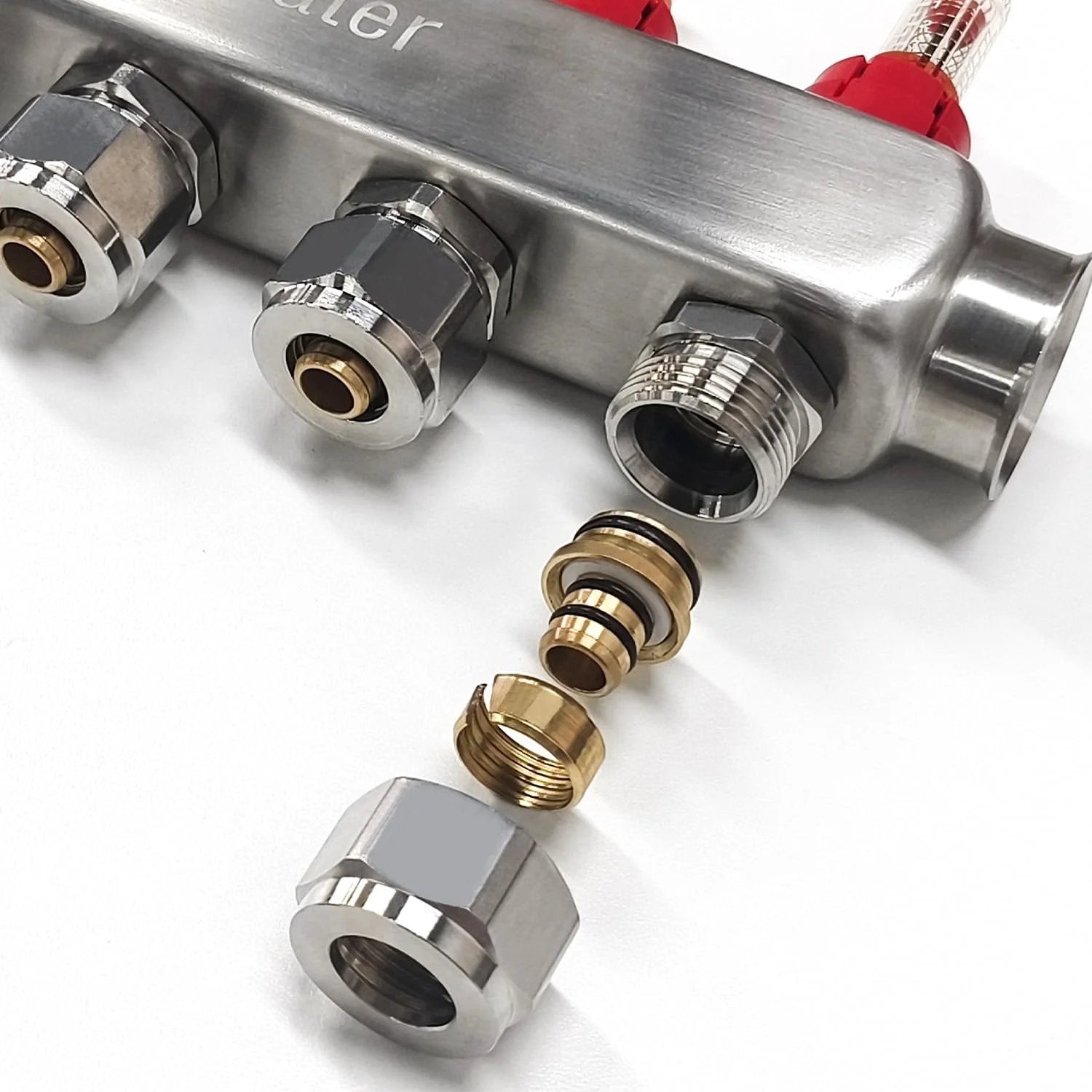 Close-up of AB 12 Loop PEX Radiant Manifold for Hydronic Floor Heating with half inch outlets and accessories, stainless steel.