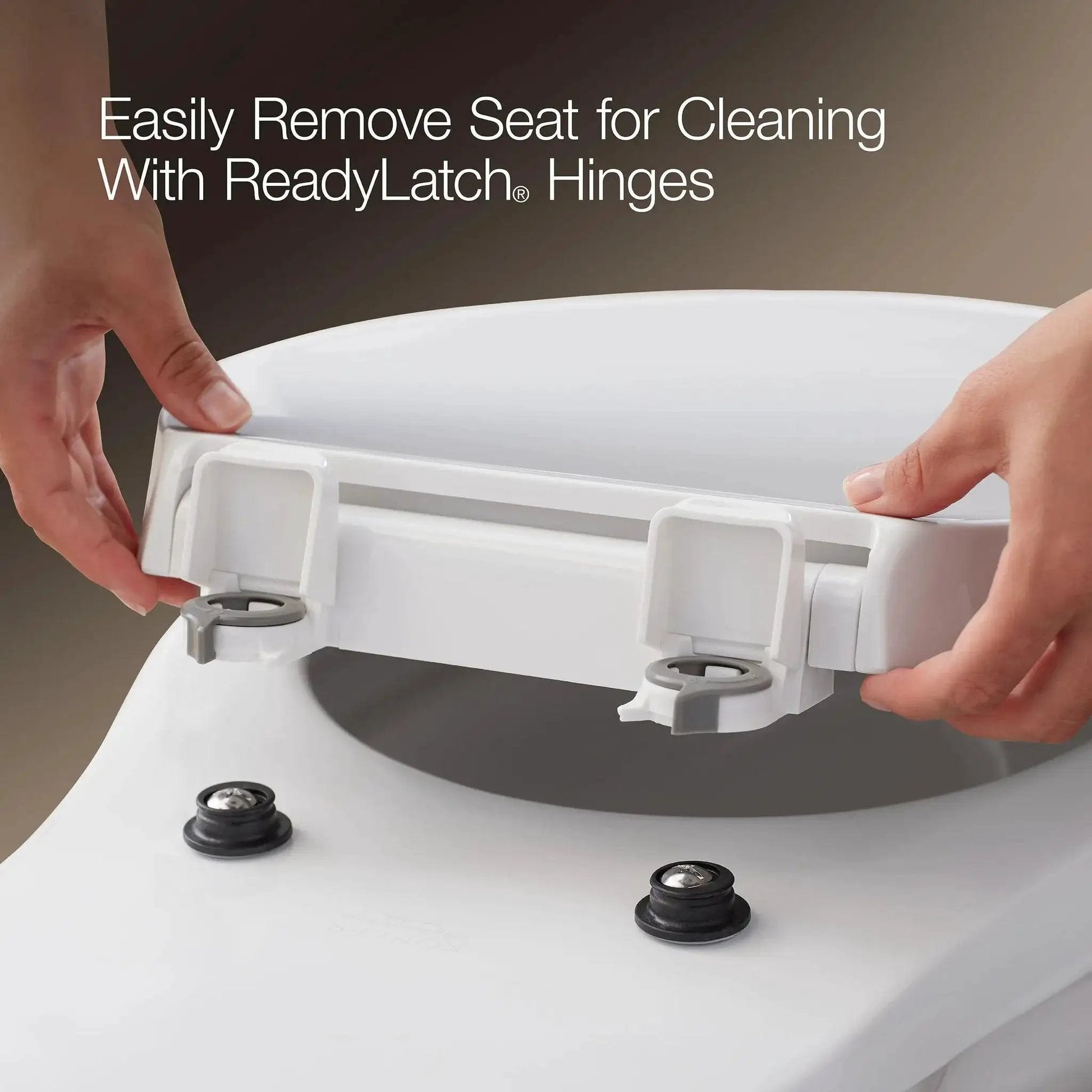 Close-up of hands removing Cachet ReadyLatch Elongated Toilet Seat With Soft Close Lid And Easy Install, showing hinges and bumpers.