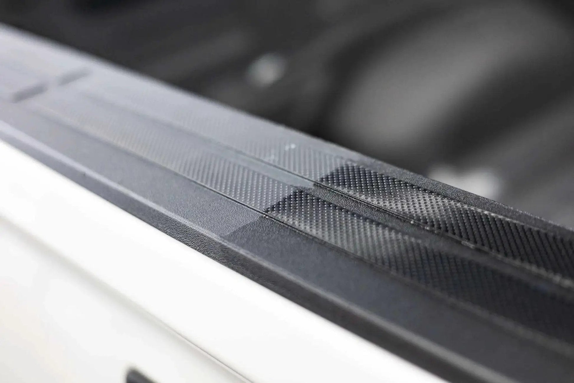Close-up of car exterior showing restored black trim using Trim And Exterior Plastic Restorer With UV Protection Up To 2 Years 50 Ml