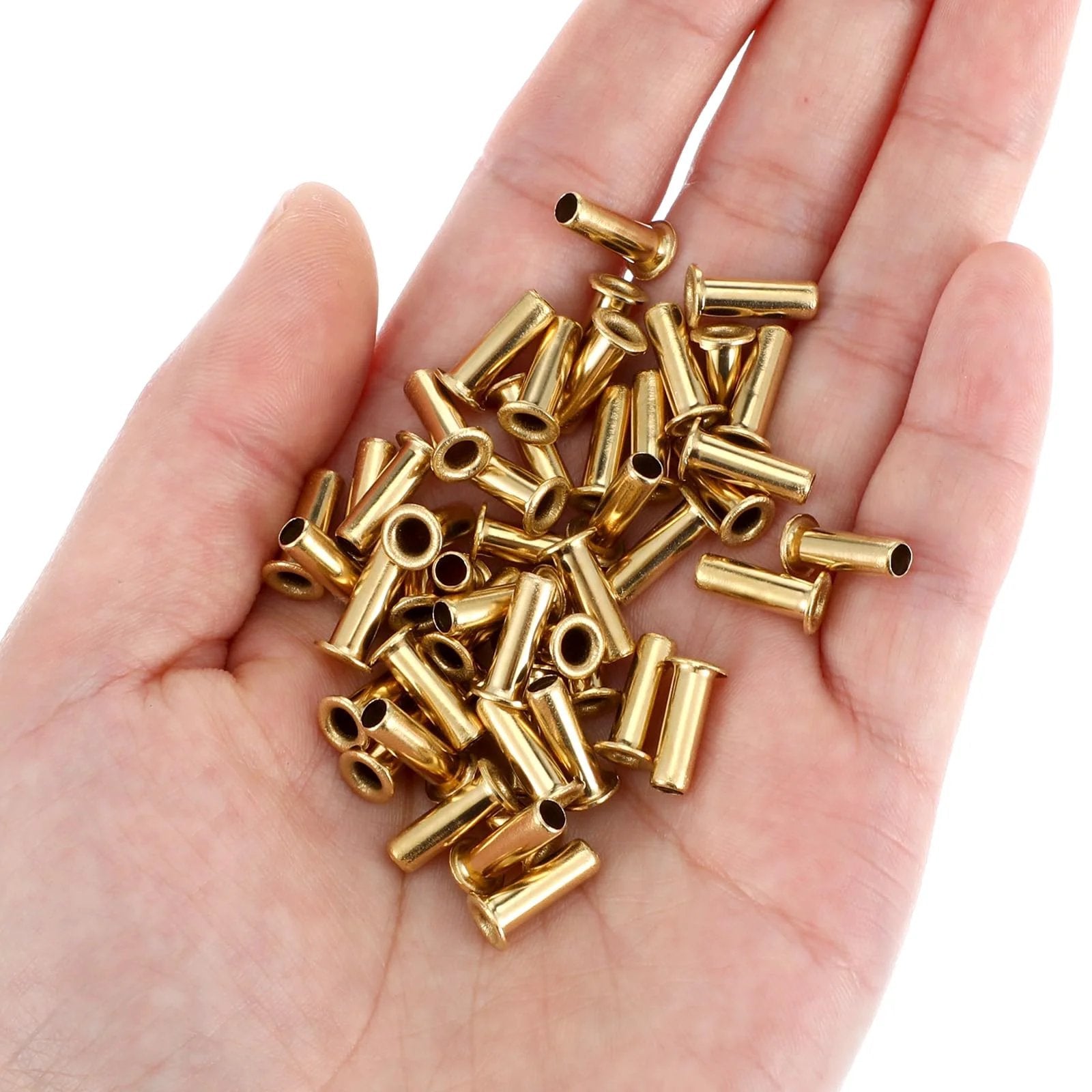 Close-up of Gold Tone Brass Compression Fittings Set For Tubing One Quarter Inch ID And Four Millimeter OD in a hand