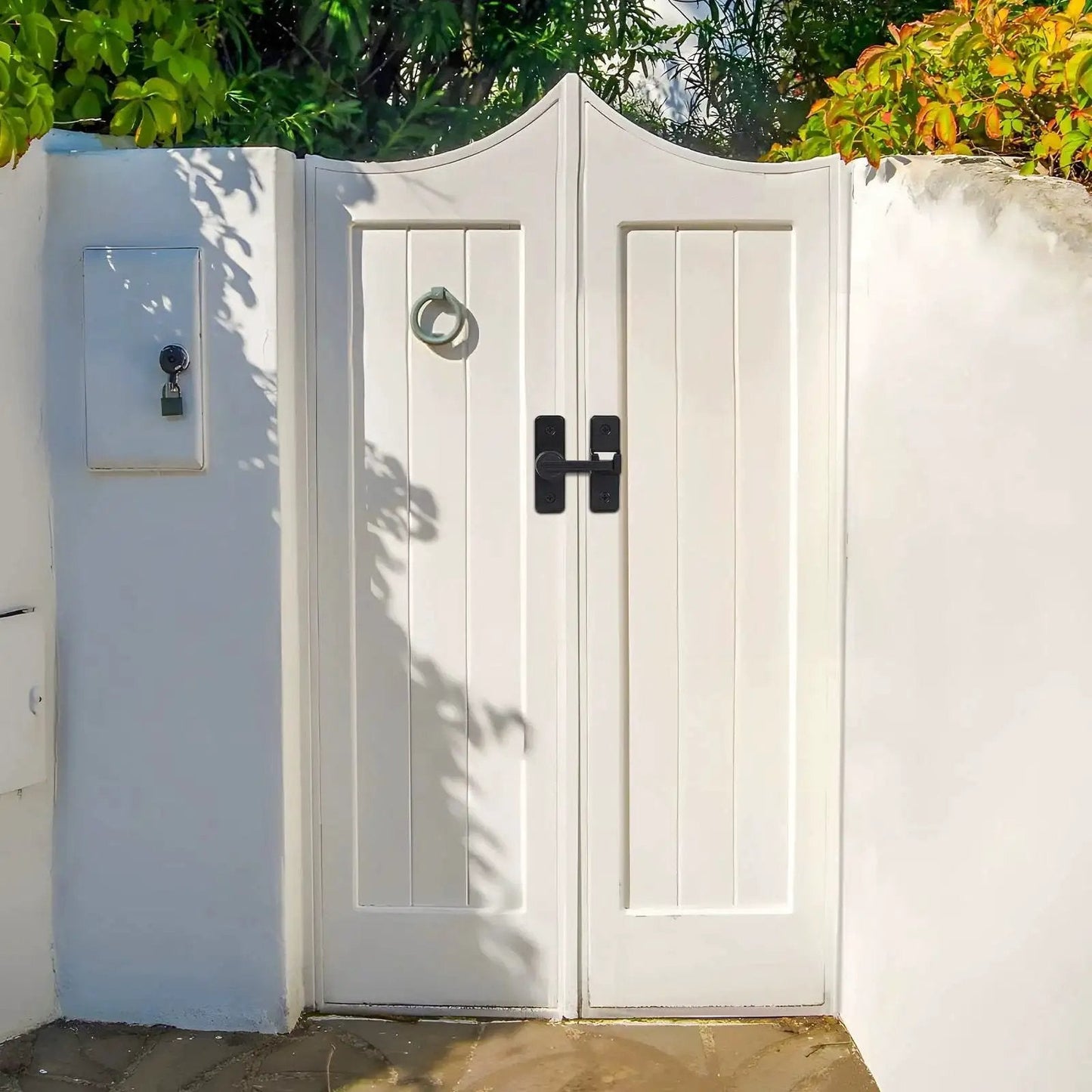 White double gate with 2 Pack Heavy Duty 180 Degree Barn Door Lock Hardware With Thickened Flip Latches, matte black finish, installed outdoors.