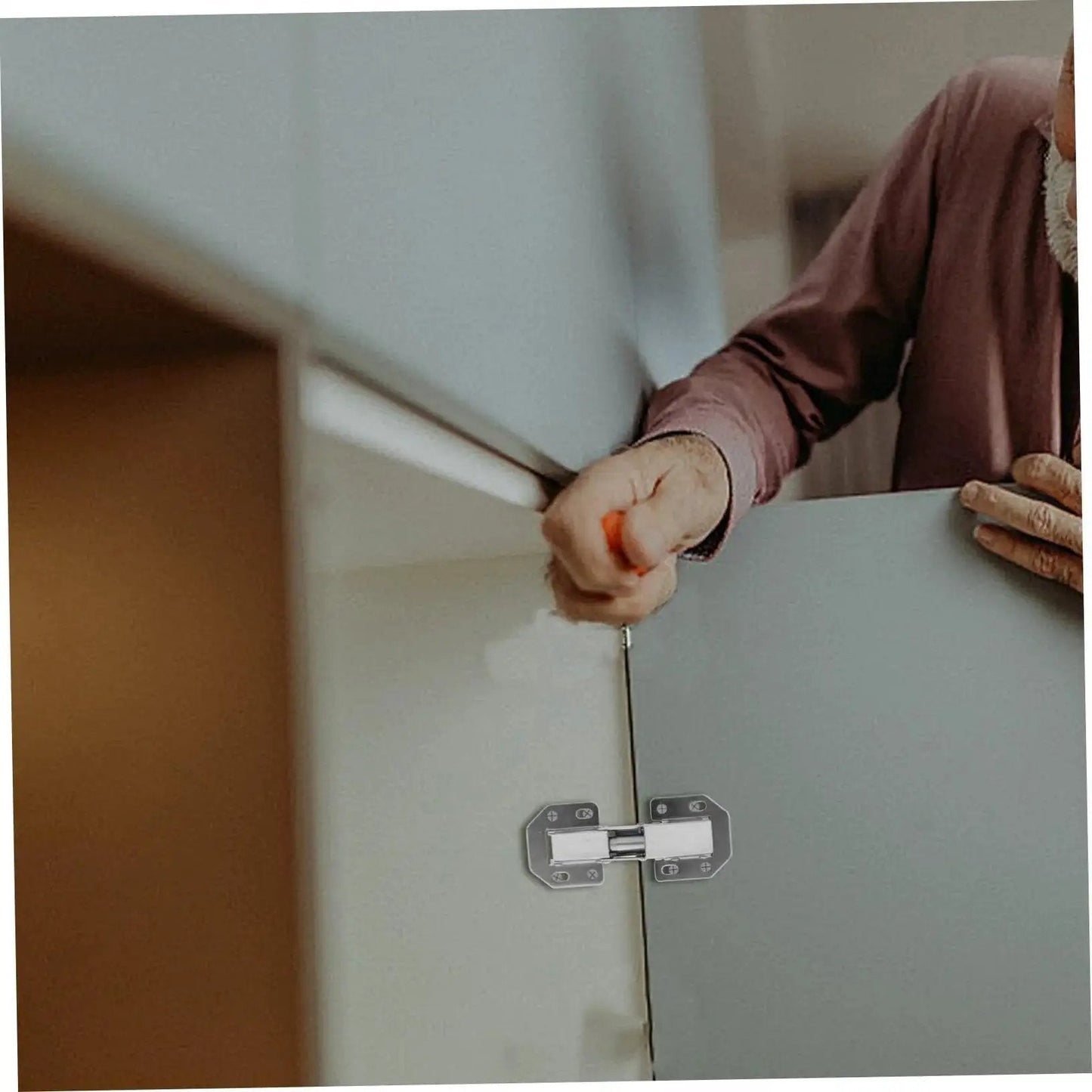 Man installing Wardrobe Hinge Repair Kit with High Load Bearing Capacity and Symmetrical Design for kitchen cabinet doors