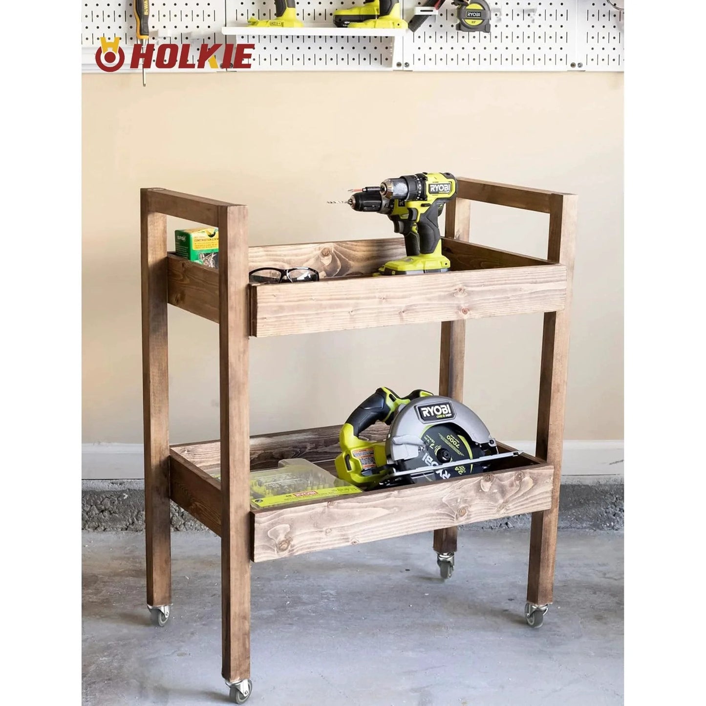 Wooden cart with 3 inch swivel caster wheels, tools on shelves, showcasing mobility in workshop setting. 600 pound load capacity, grey casters.