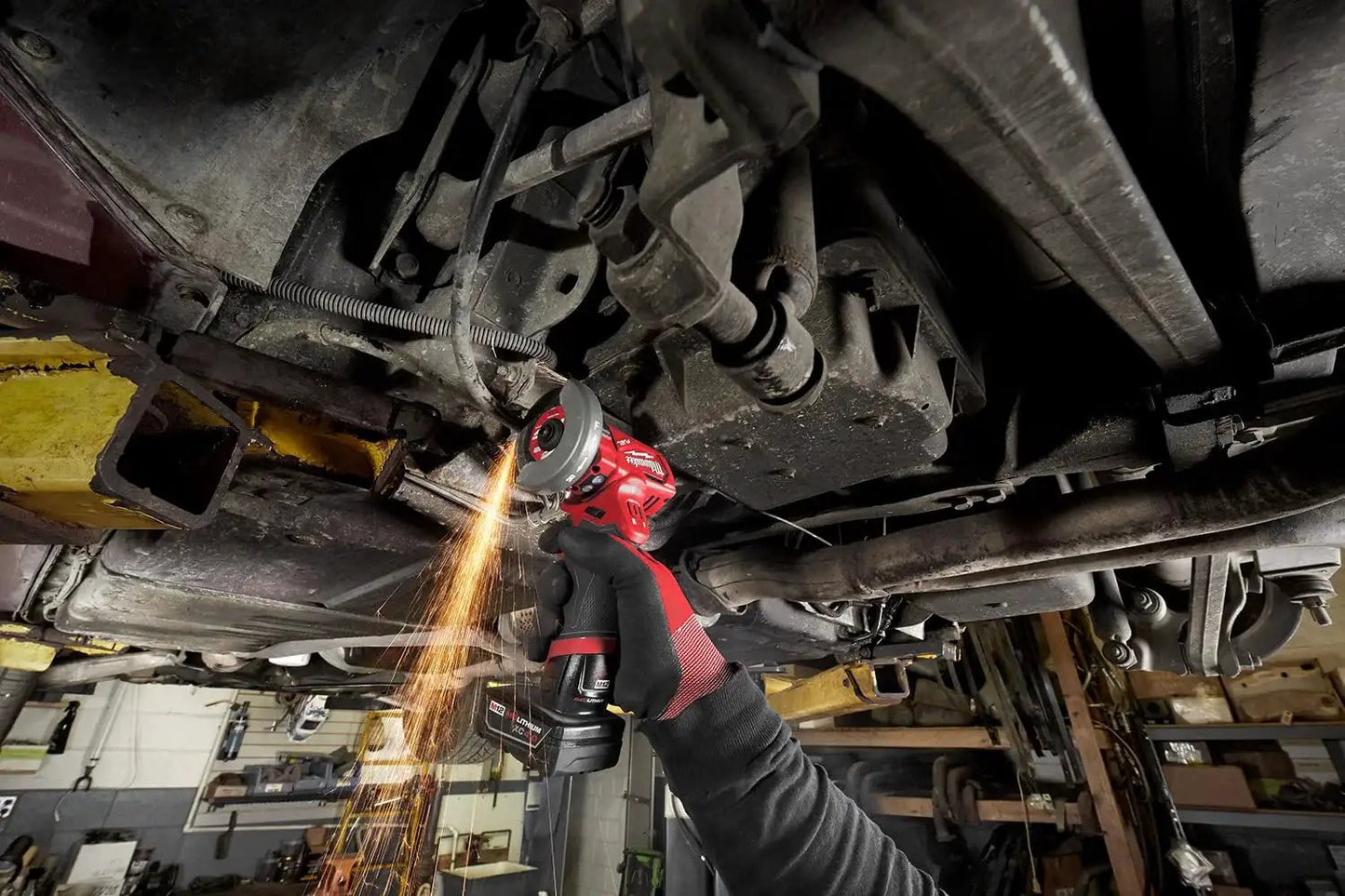 Using Compact 12V Cut Off Tool Bare Tool with Reversible Blade Rotation for metal cutting under a vehicle