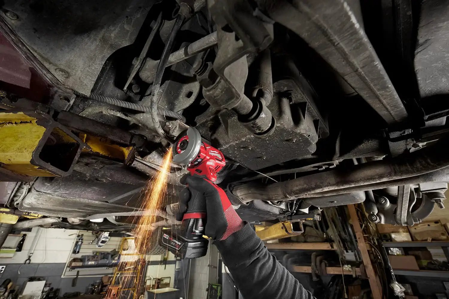 Using Compact 12V Cut Off Tool Bare Tool with Reversible Blade Rotation for metal cutting under a vehicle