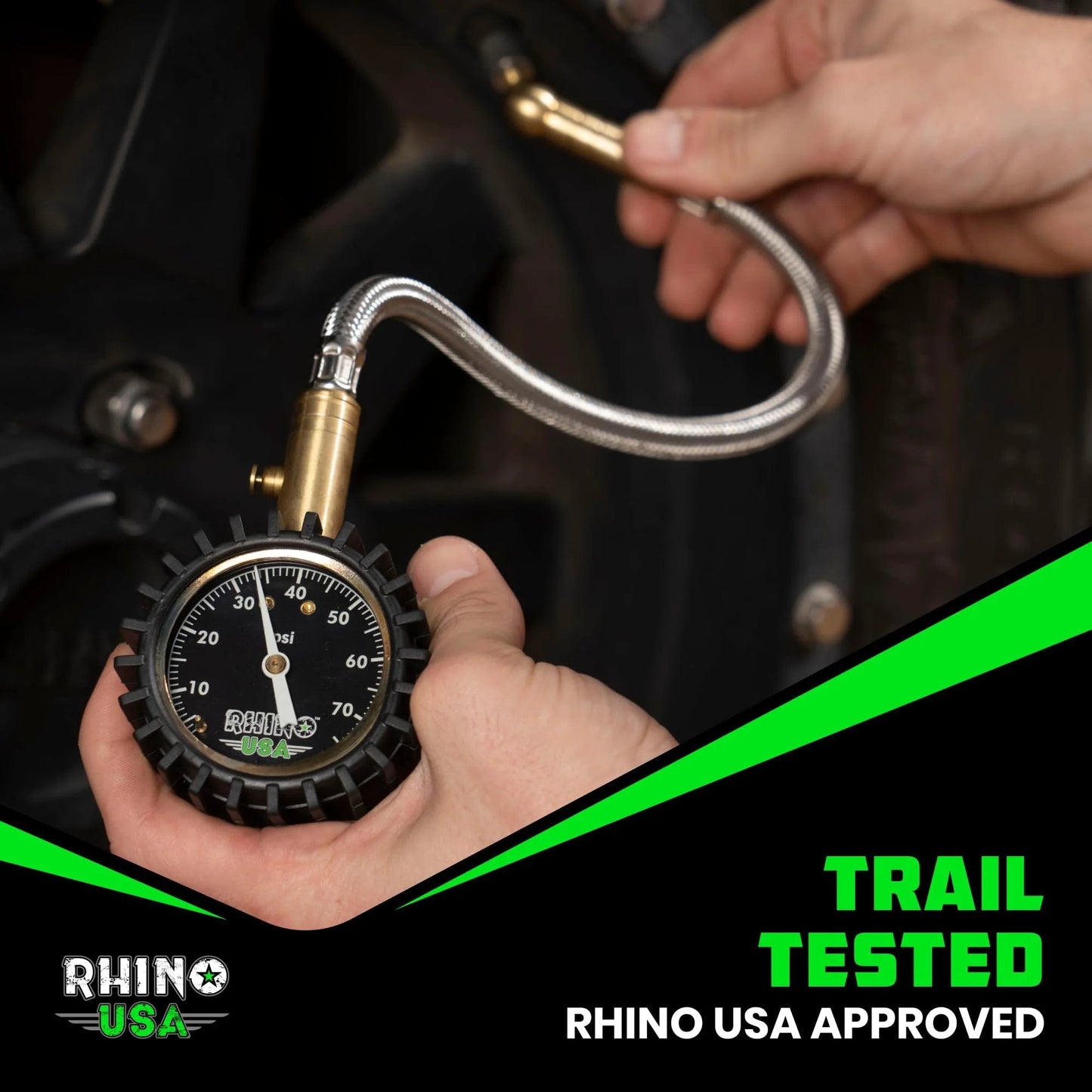 Heavy Duty Tire Pressure Gauge 0 To 75 PSI With Large Glow Dial And Premium Braided Hose For Cars Trucks Motorcycles And RV ANSI B40 1 Certified Solid Brass Hardware By Rhino USA being used on vehicle wheel