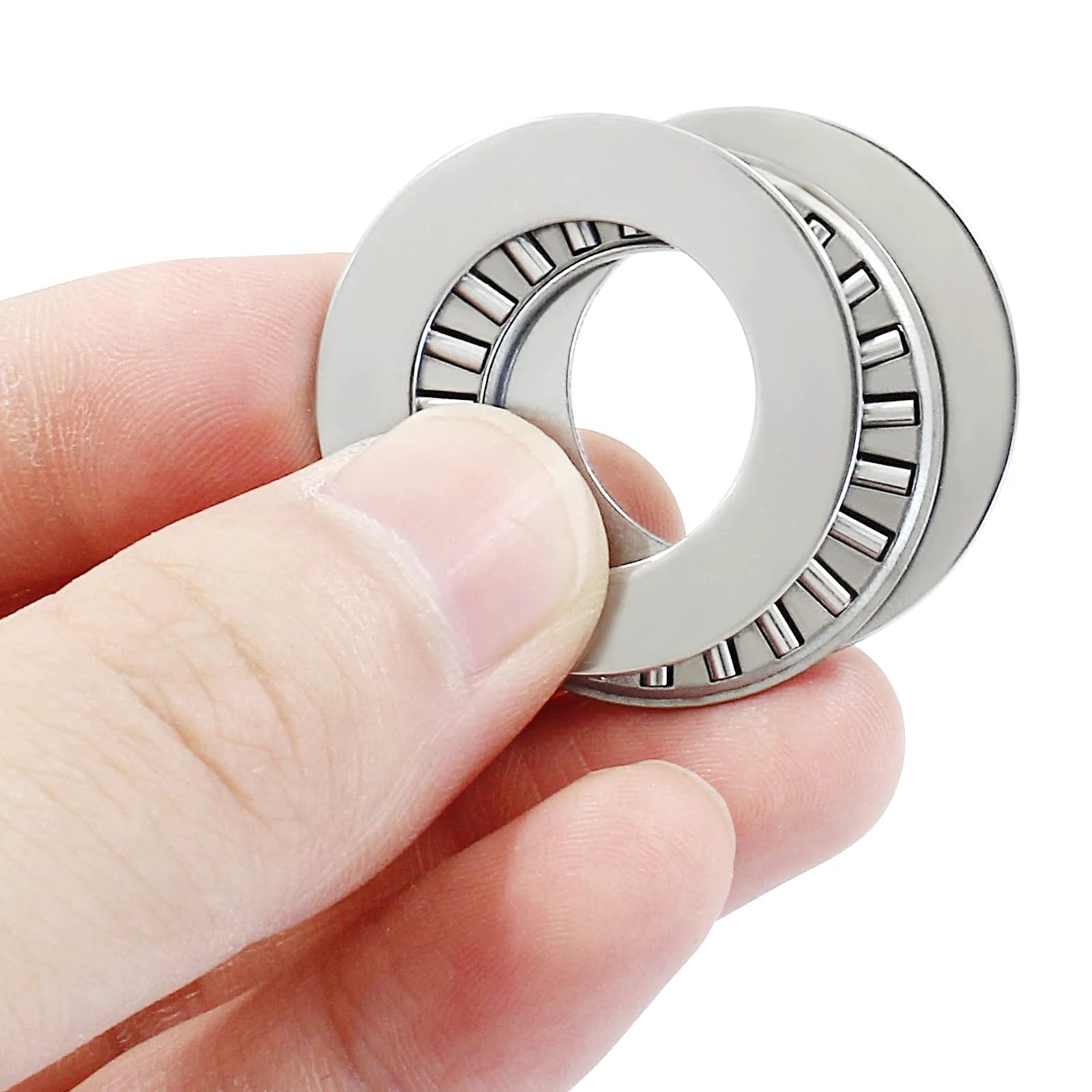Person holding Two Pack NTA1220 1.25 Inch Outer Diameter Thrust Needle Roller Bearings With Washers Inner Diameter 0.75 Inch
