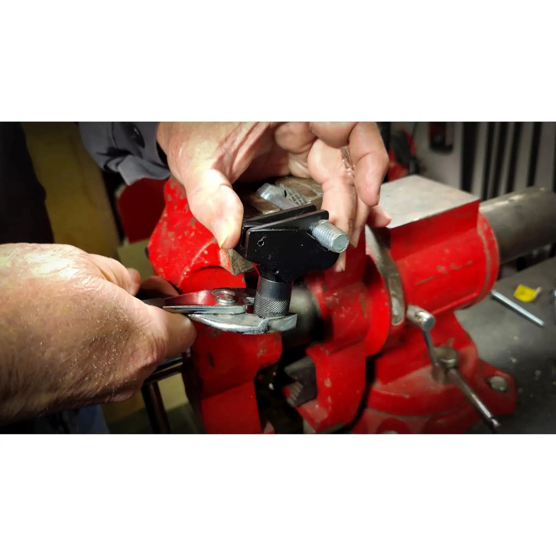 Close-up of Universal Thread Repair Tool for SAE and Metric Threads with Adjustable Pitch being used in a workshop setting