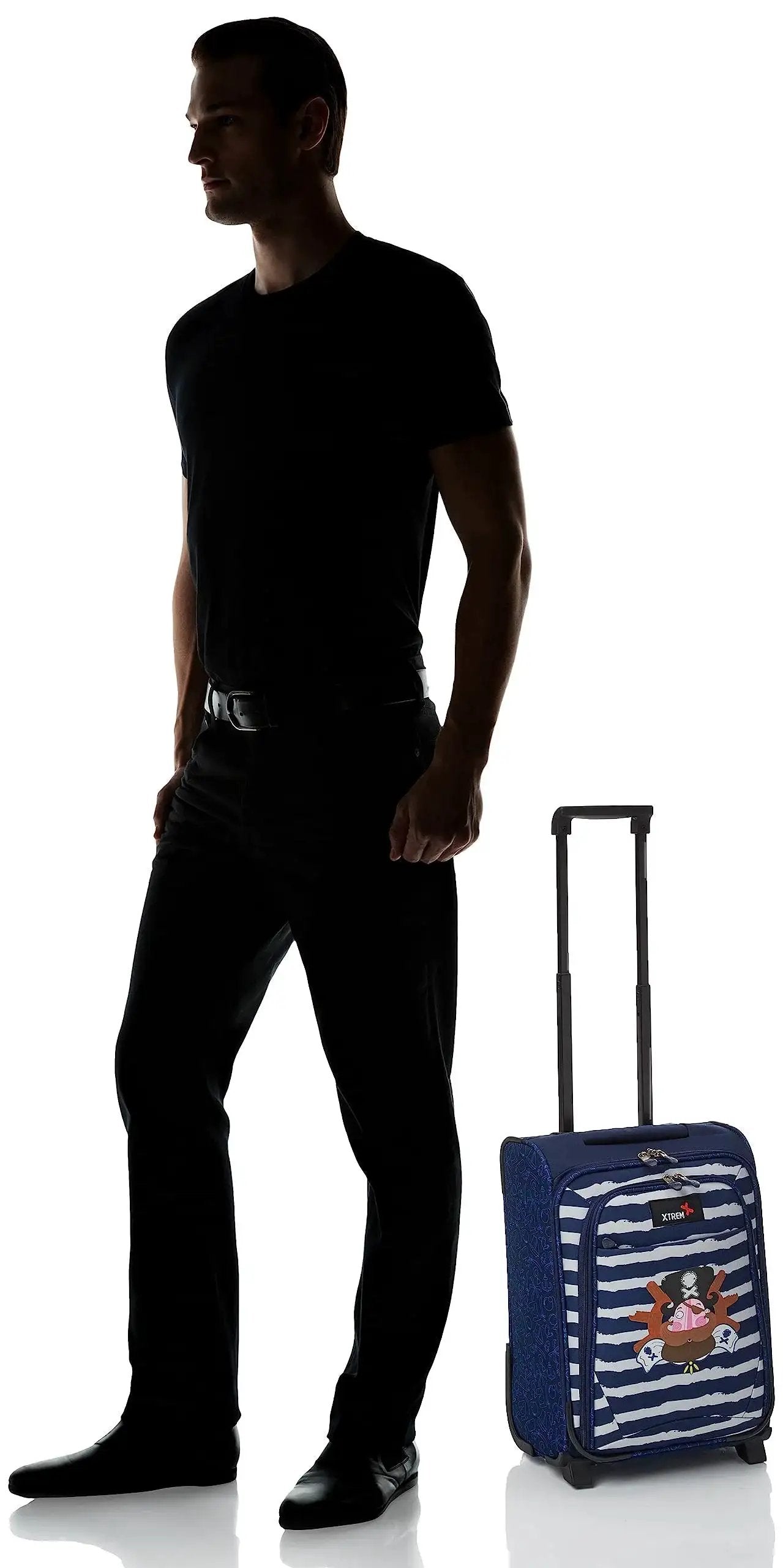 Man standing beside navy blue rolling suitcase with pirate design, showing size comparison, telescopic handle extended