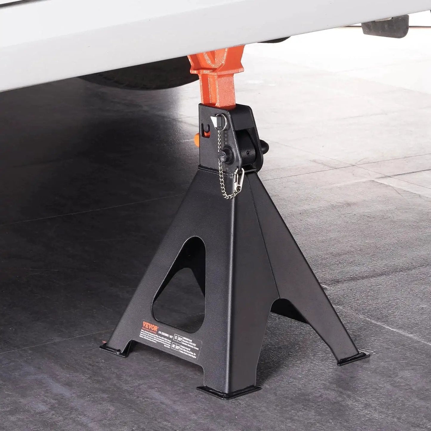 6 Ton Jack Stands With Double Locking Adjustable 14.2 To 23 Inches For SUV UTV under a vehicle, side view in garage setting.