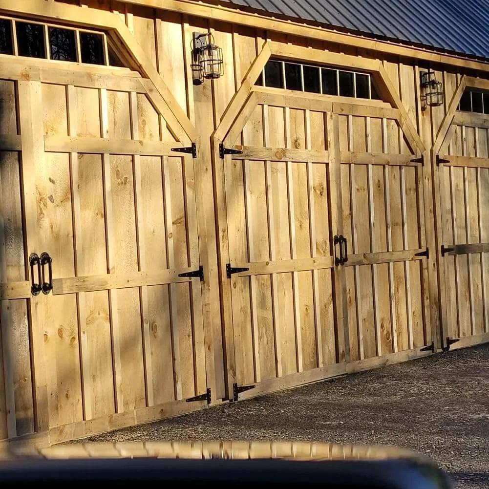Wooden barn doors with installed 8 Inch T Strap Barn Door Hinges Heavy Duty Gate Hinge Set Black Wrought Iron Rustproof 6 Pcs