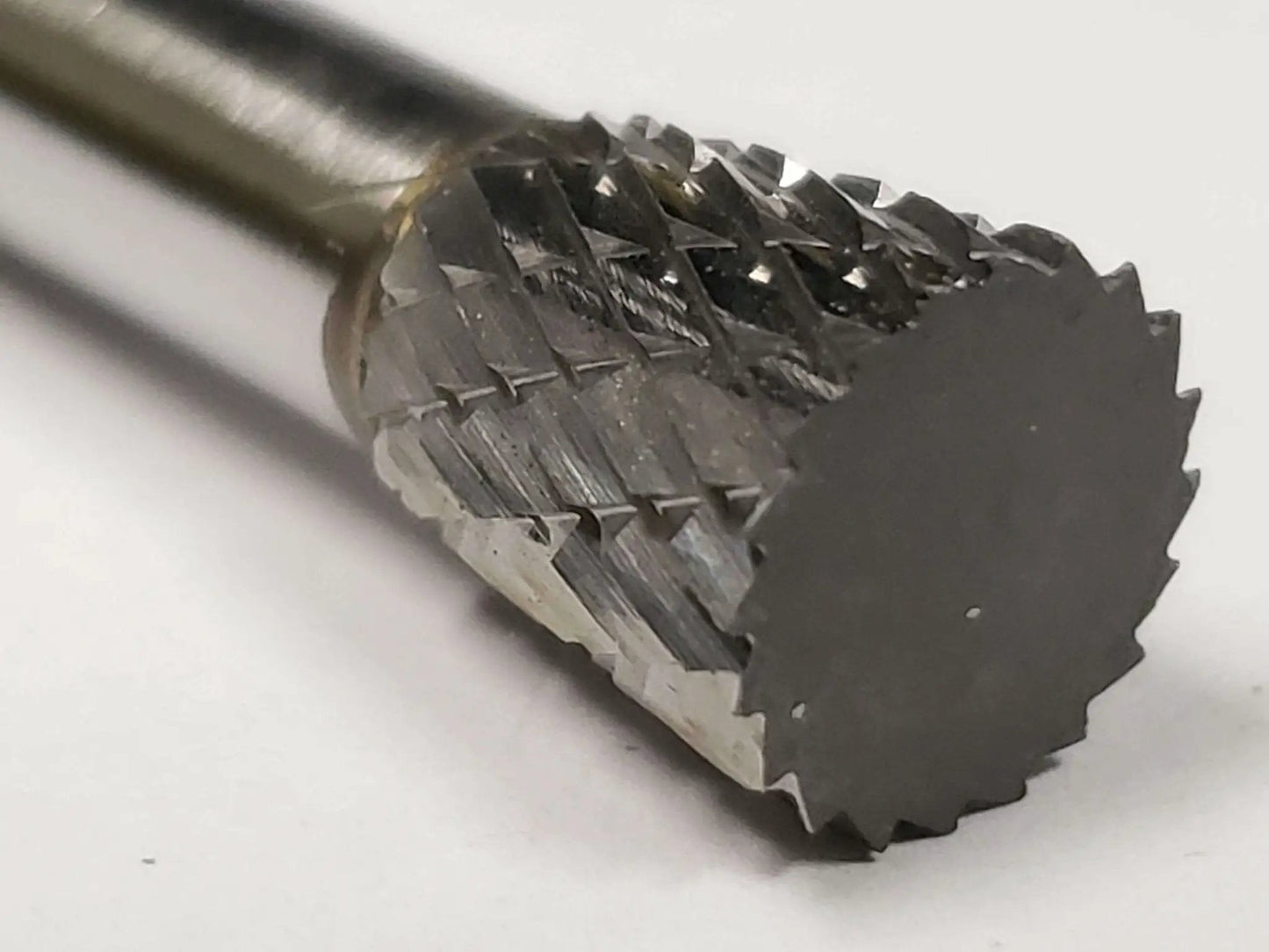 SN 2 Inverted Cone Carbide Burr With Double Cut For Metalworking, Three Eighths Inch Shank, shown in close-up from an angle.