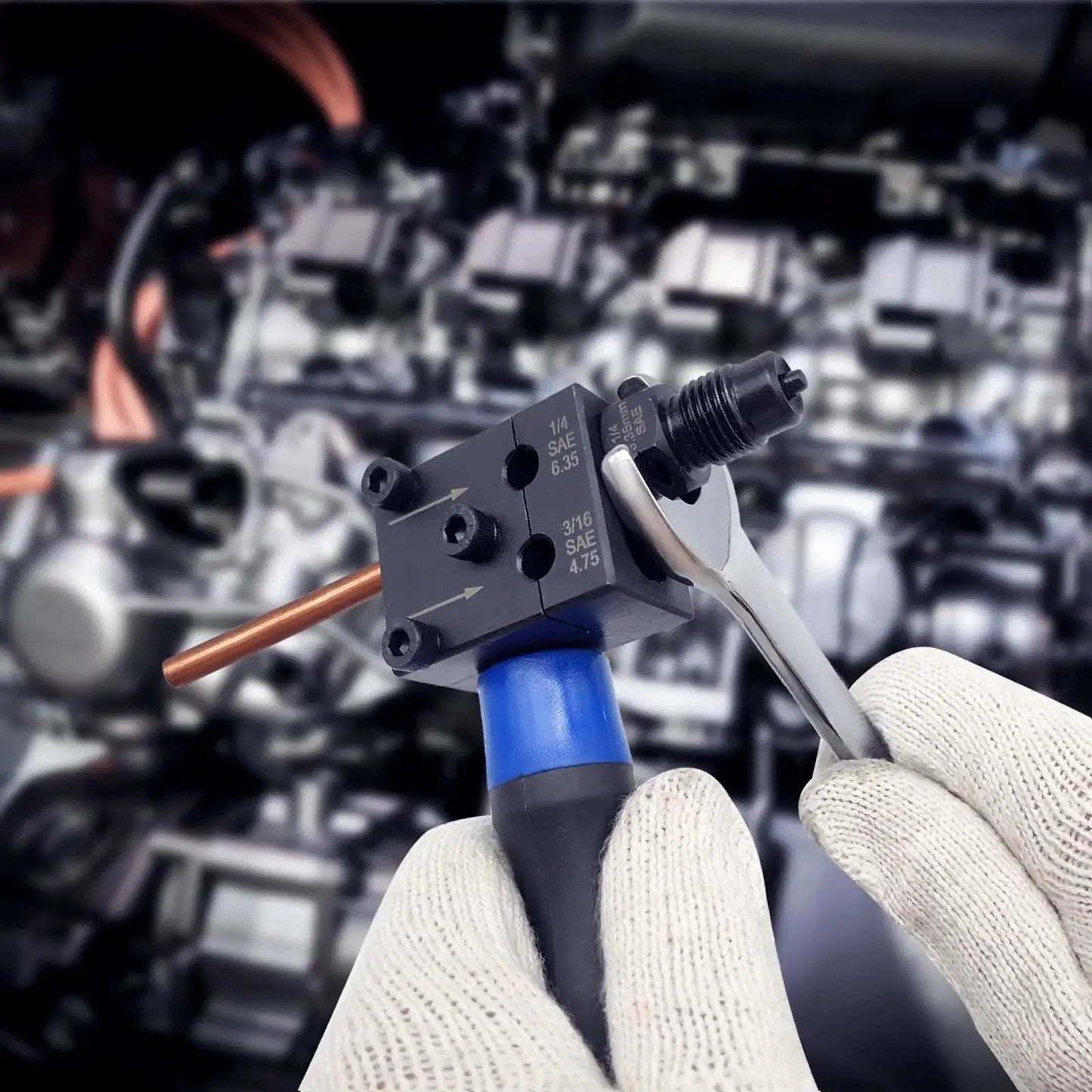 Gloved hands using a Double Flare Tool Kit for Brake Lines Three Sixteenth and One Quarter Inch on copper tubing in engine bay