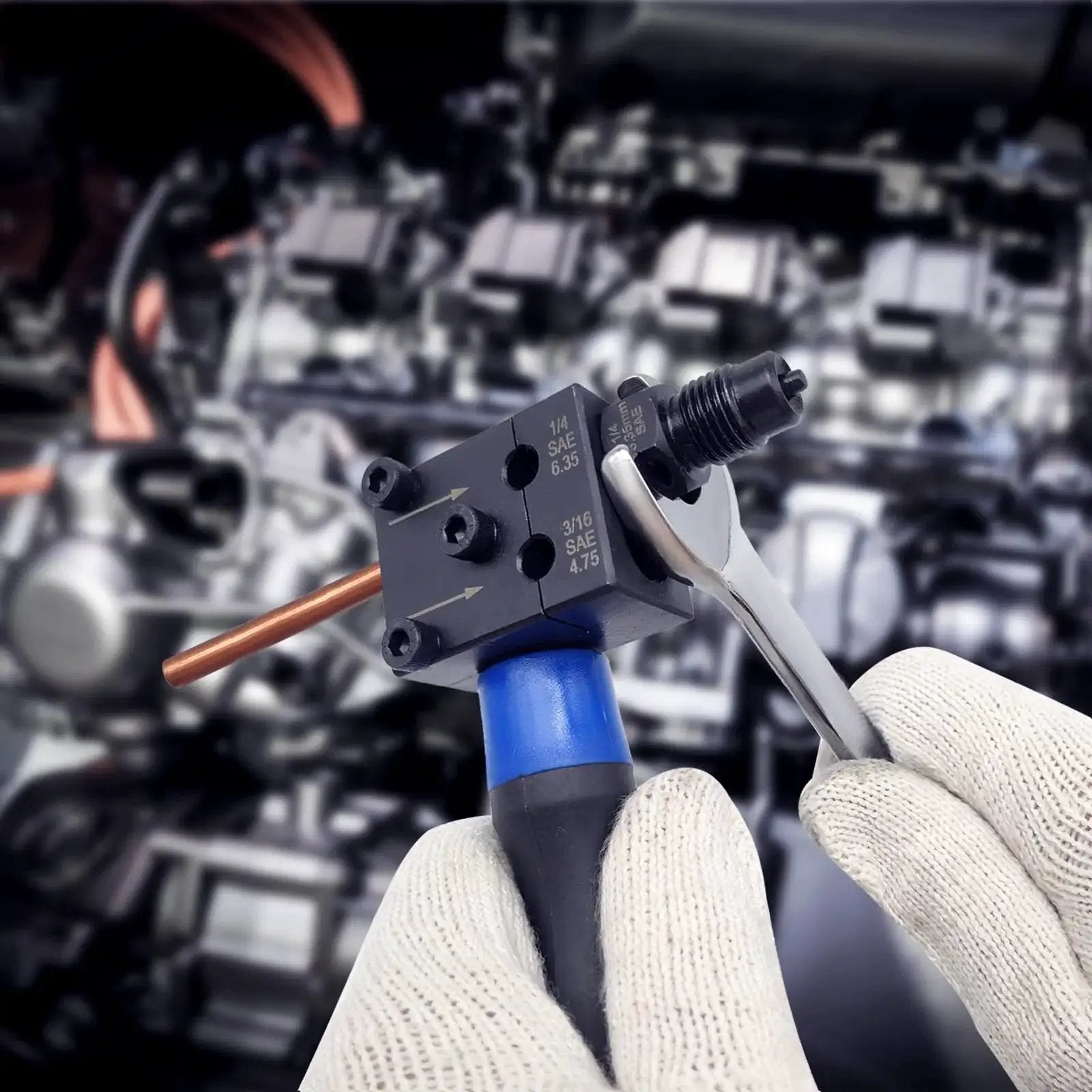 Gloved hands using a Double Flare Tool Kit for Brake Lines Three Sixteenth and One Quarter Inch on copper tubing in engine bay