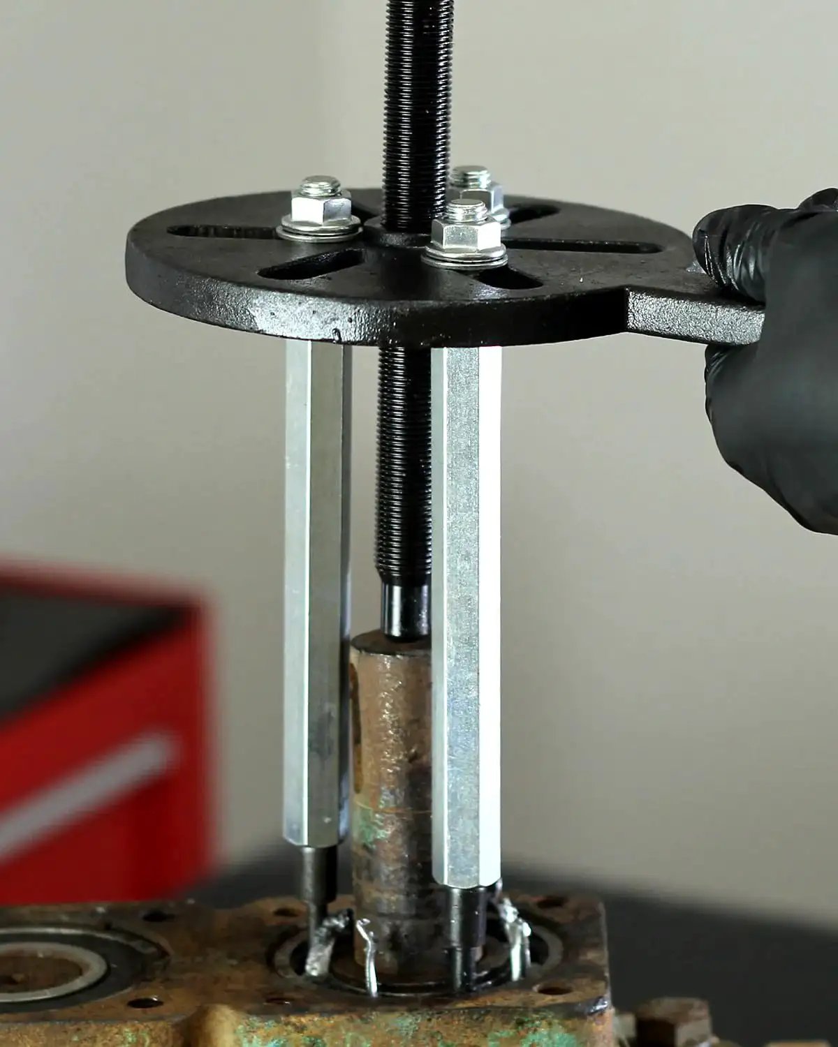 Inner Hole Bearing Puller Set With Three Jaw Design And Curved Hook Rod in use, pulling a recessed bearing from machinery component