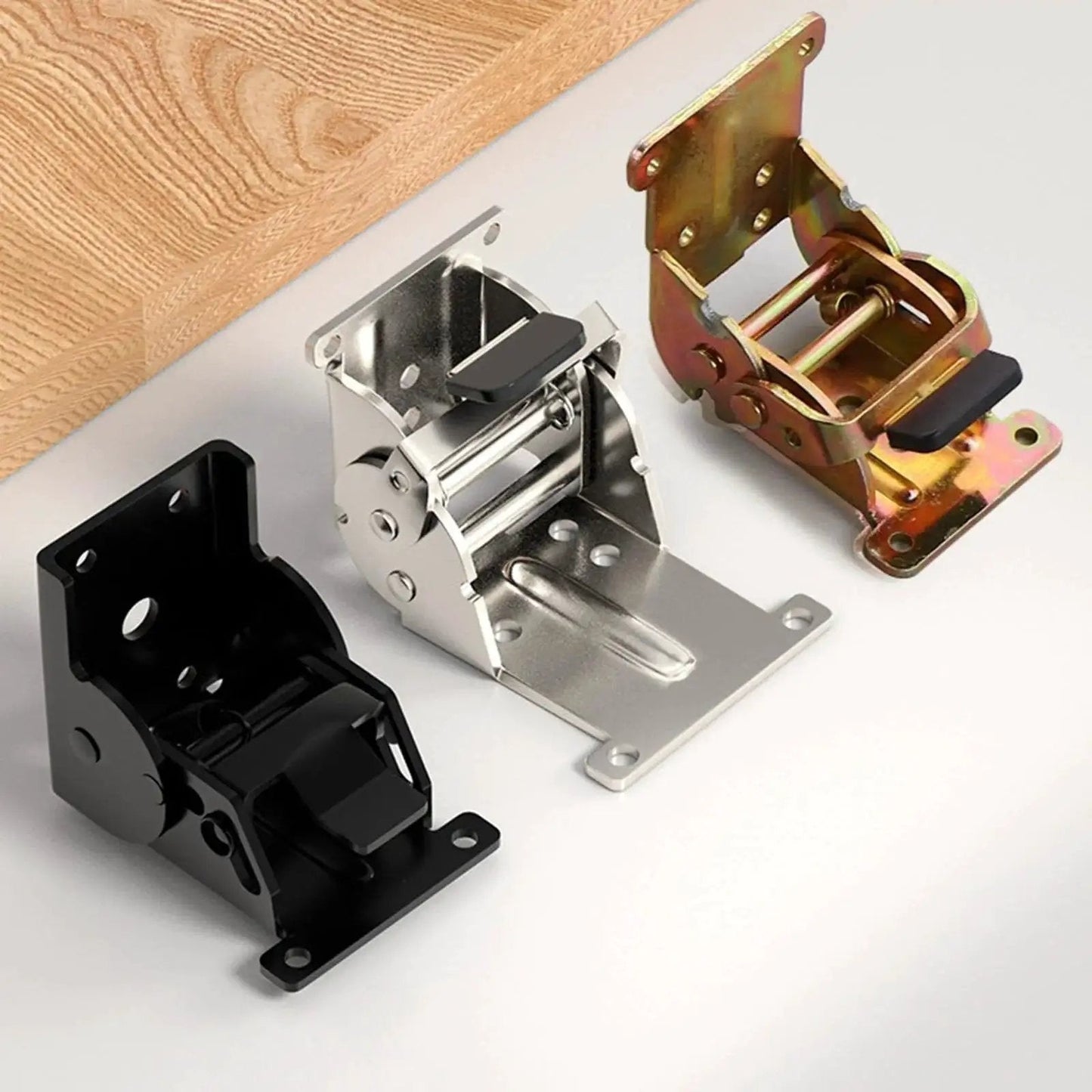 Three industrial locking hinges with 180 degree foldable leg brackets for tables, beds and workbenches on a tabletop