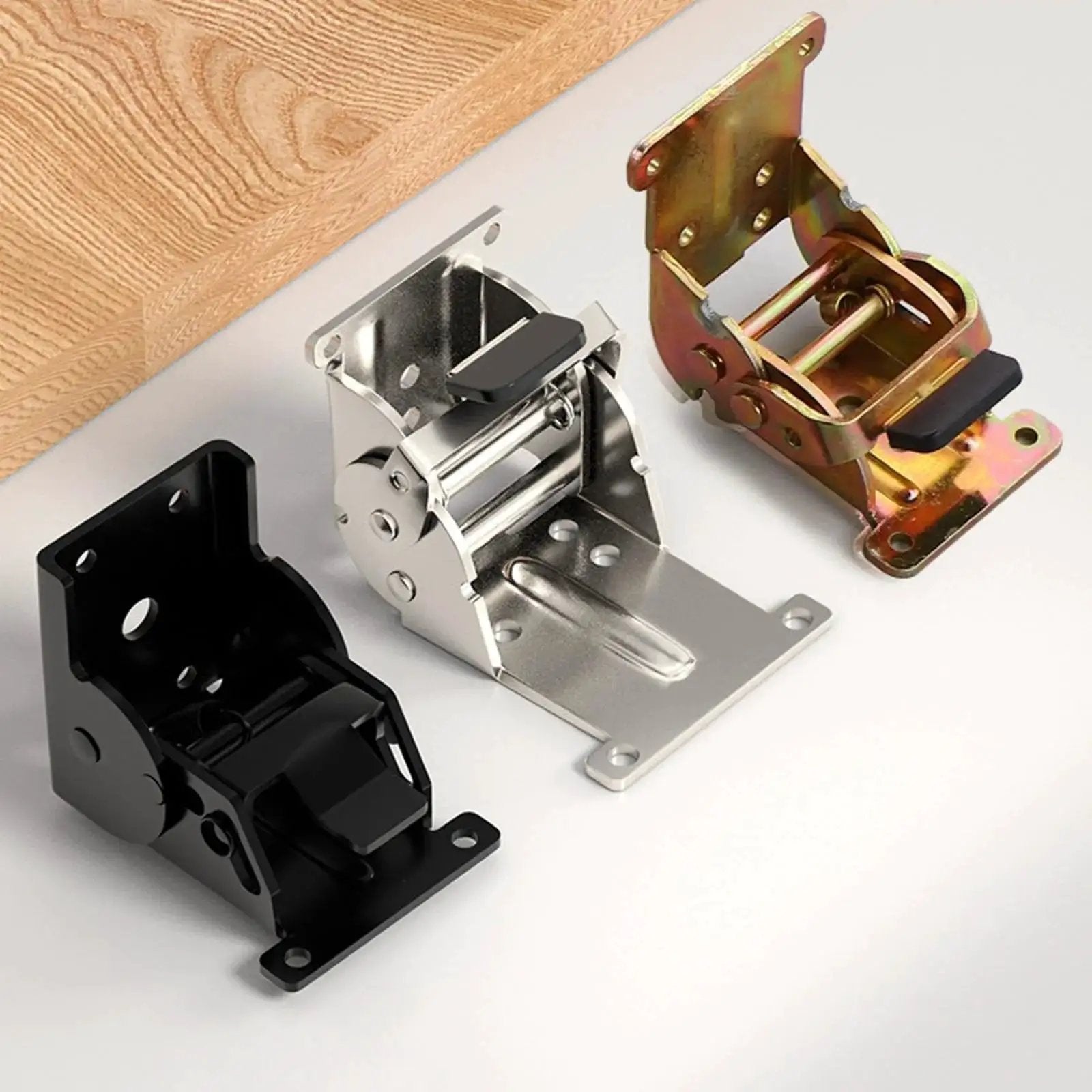 Three industrial locking hinges with 180 degree foldable leg brackets for tables, beds and workbenches on a tabletop
