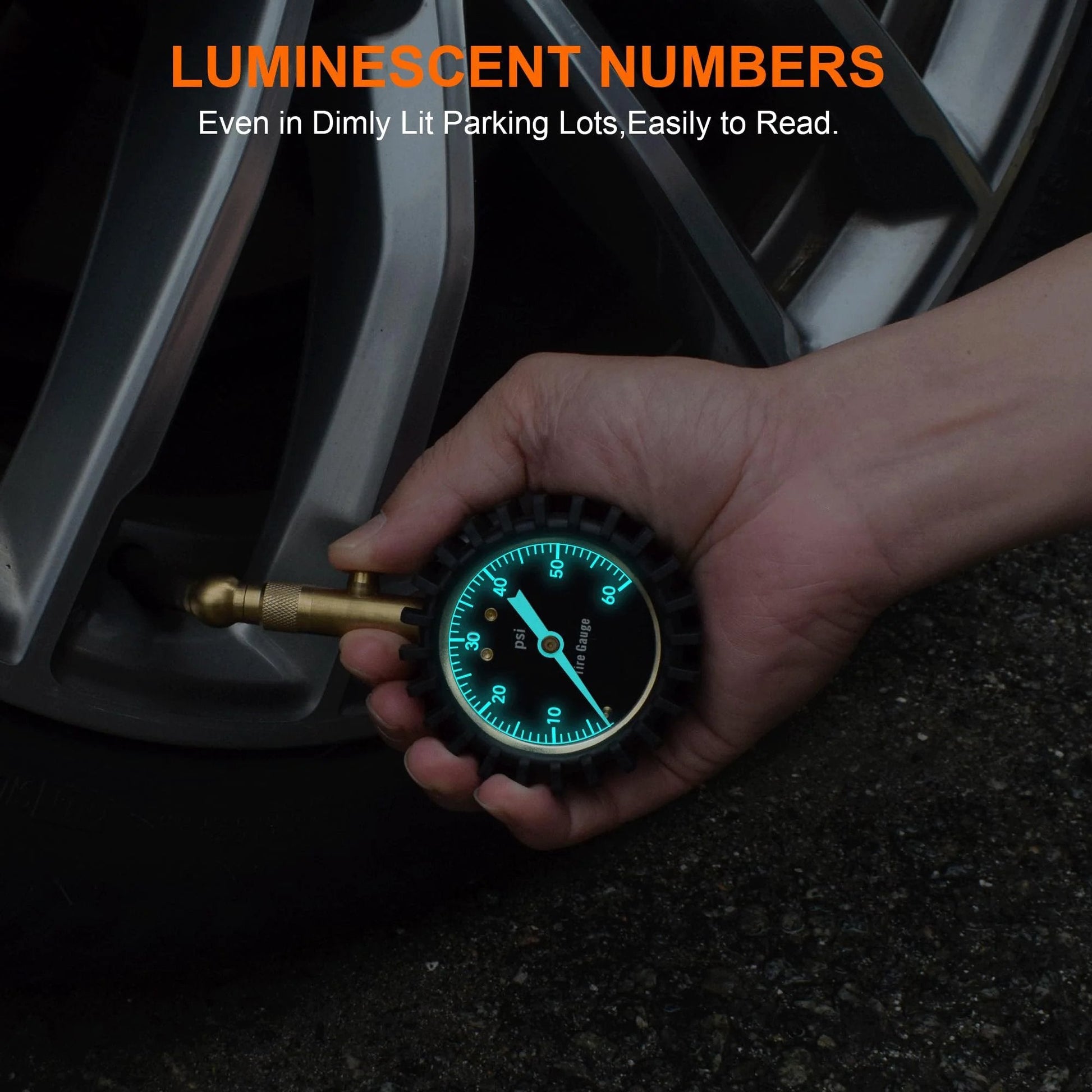 Glowing Dial Tire Pressure Gauge for Cars 60 PSI with Illuminescent 2 Inch Dial checking tire pressure in dark lighting.