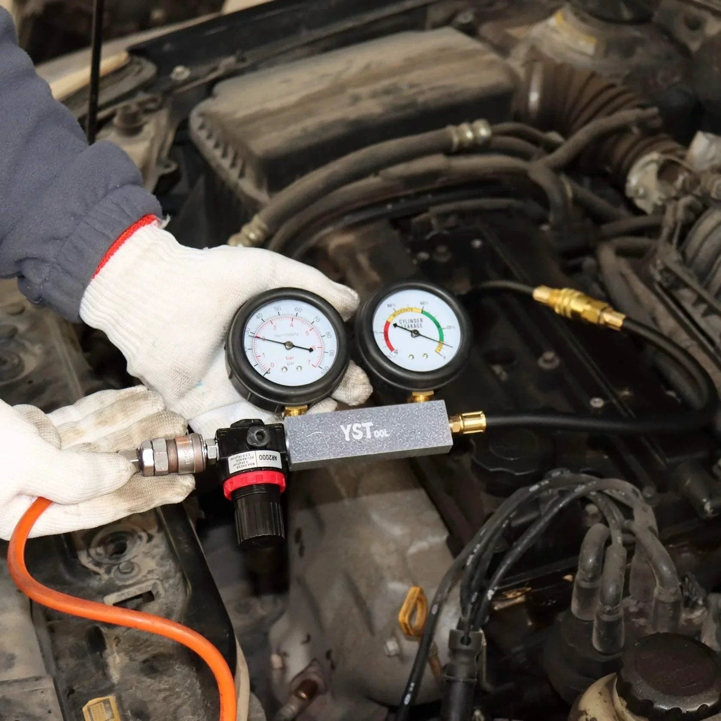 Leak Down Tester Kit For Cars And Small Engines With Dual Gauge Pressure Readout in use for cylinder diagnostics on car engine.