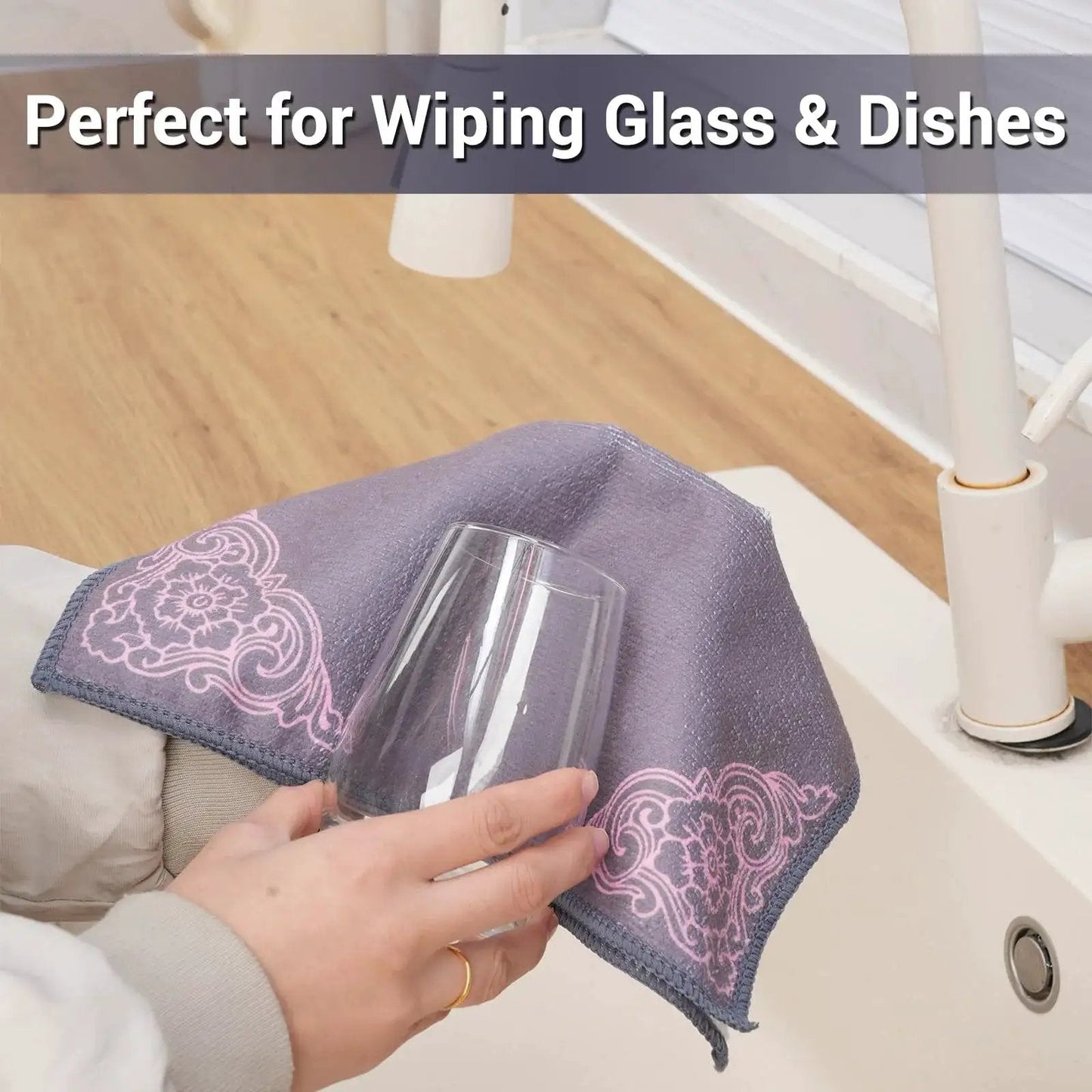 Person using a microfiber cloth to clean a glass near a sink, featuring the 12 Pack Microfiber Cleaning Cloths For Cars And Home Ultra Absorbent Towels.