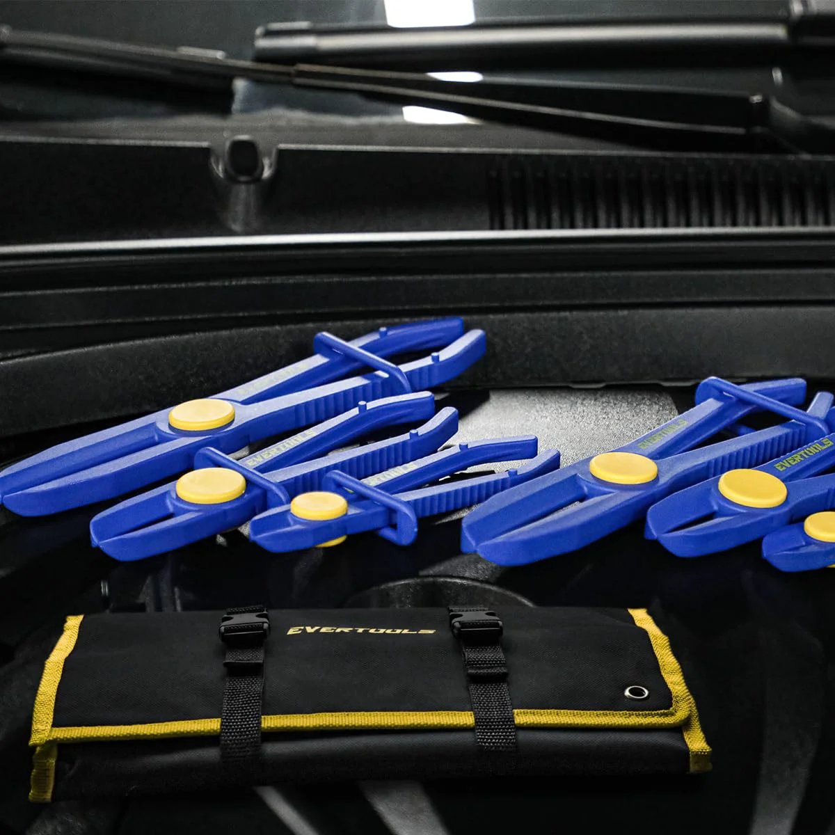 6 Piece Hose Pinch Clamp Pliers Set For Brake Fuel Radiator Hoses All In One Kit With 3 Sizes And Oxford Tool Bag Perfect Gift For Dads And DIYers By Evertools, showing blue pliers and black tool bag on car engine.