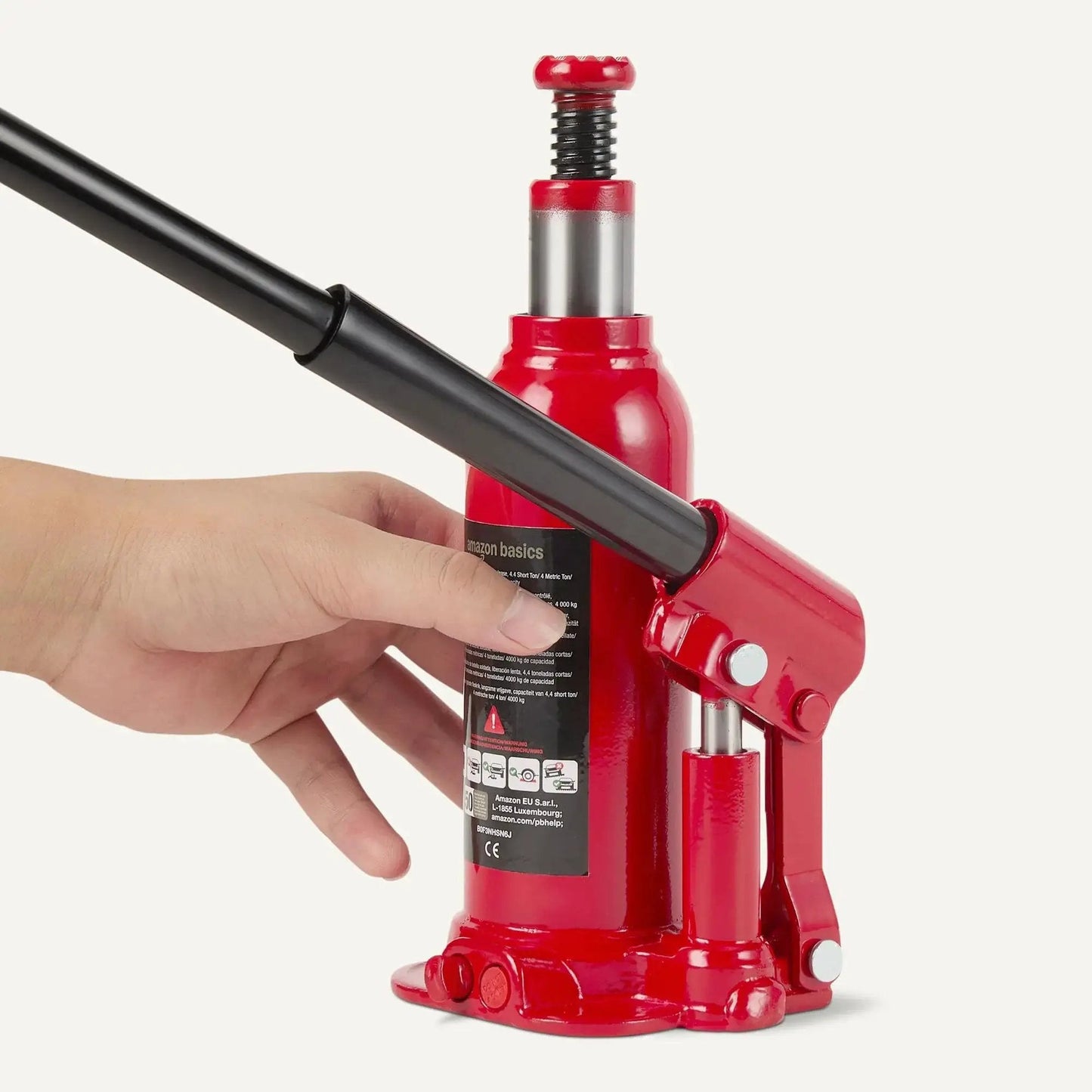 Hydraulic Bottle Jack For Vehicles With 4 Ton Capacity 4000 Kg Slow Release Valve Welded Construction Red Finish shown in hand.
