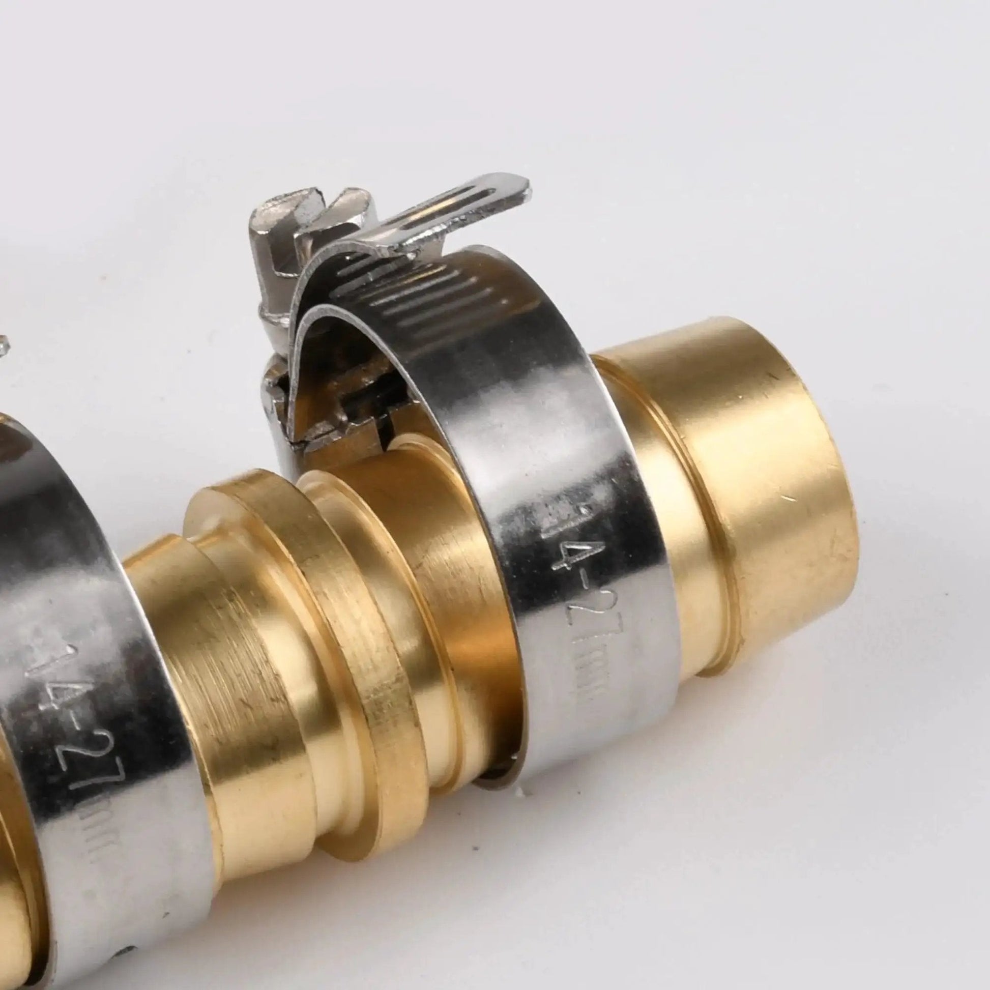 Close-up of brass hose joiner repair kit for outdoor use five eighths inch hose mender with stainless steel clamps