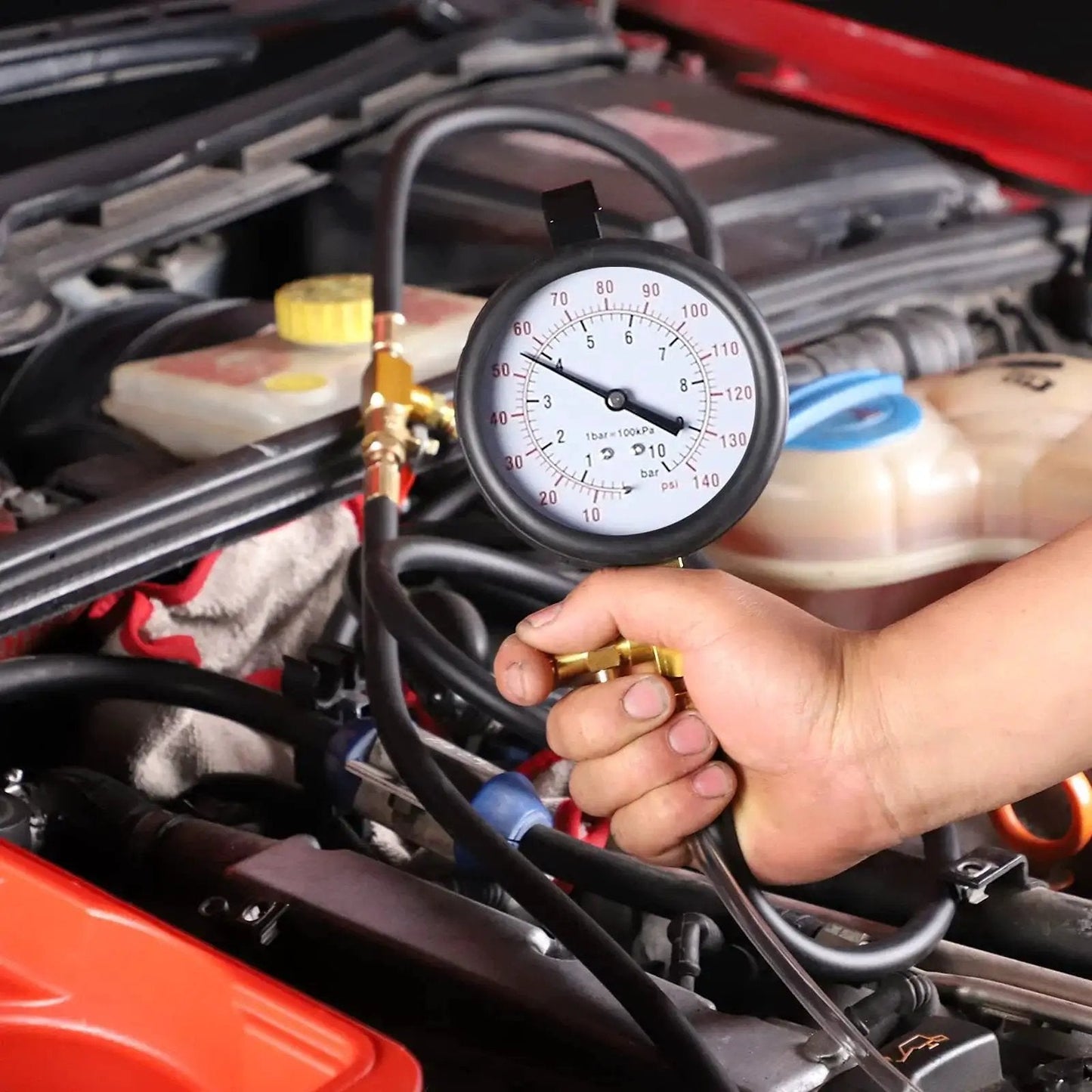 Person using Deluxe Fuel Injection Pressure Tester Kit With Dual Dial Gauge 0 To 140 PSI on car engine
