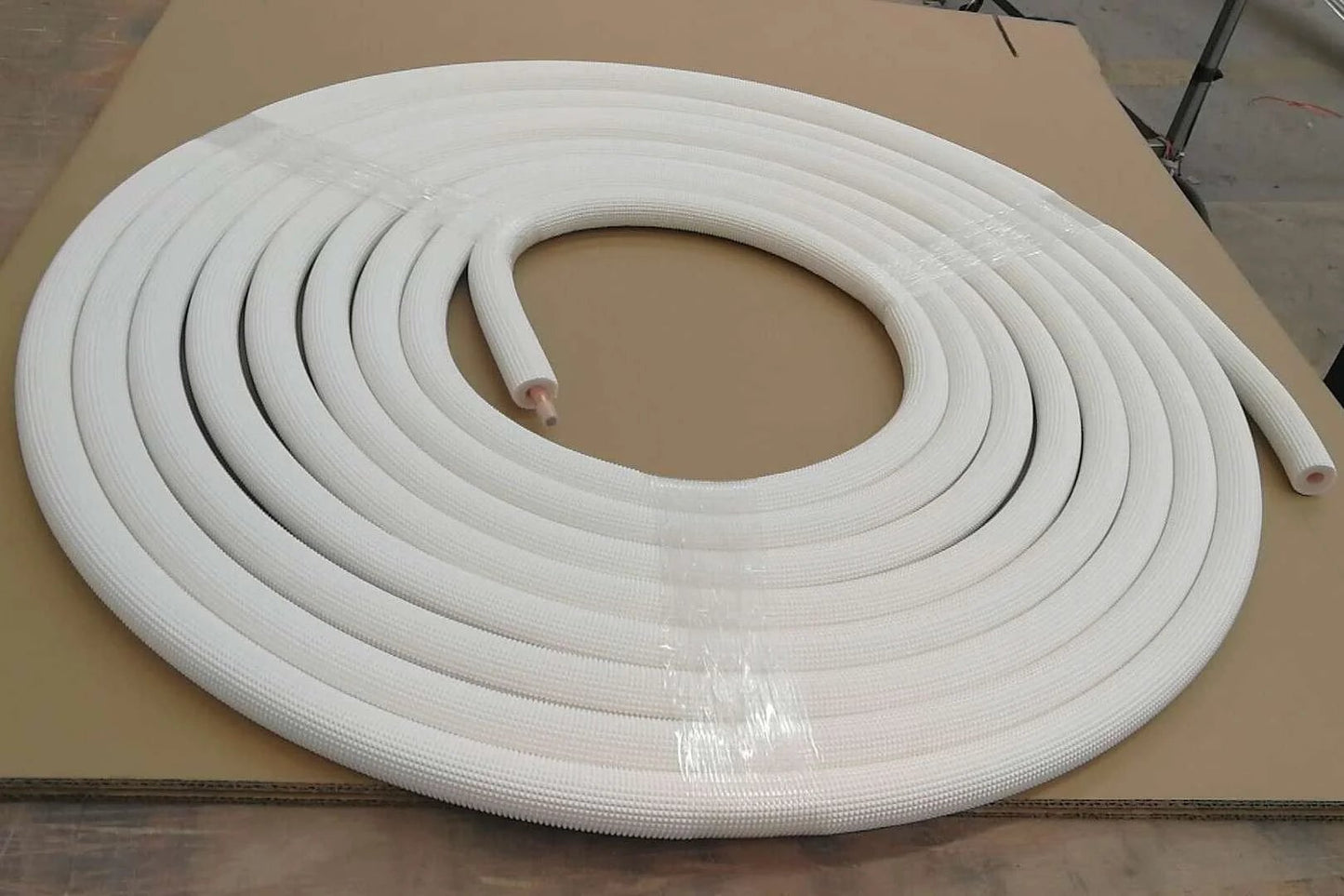 Front view of a coiled Quarter Inch Insulated Copper Coil Line For HVAC And Refrigeration, 25 feet long, with seamless copper tube and white insulation.