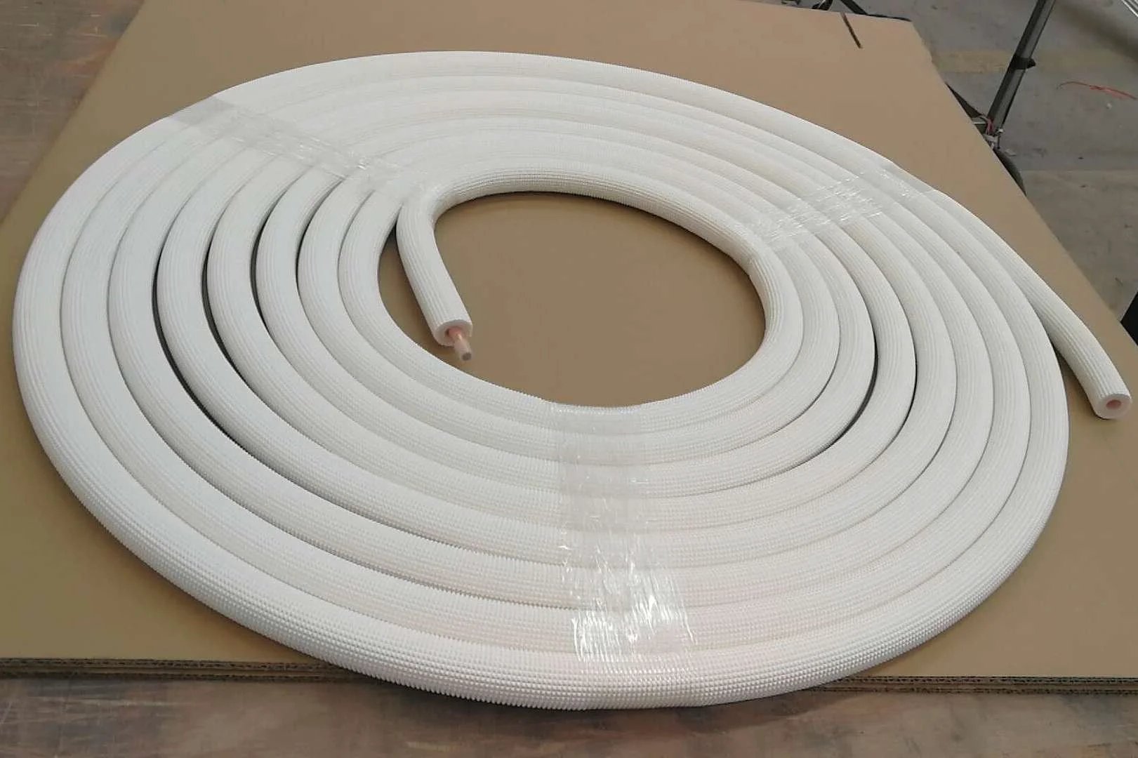 Front view of a coiled Quarter Inch Insulated Copper Coil Line For HVAC And Refrigeration, 25 feet long, with seamless copper tube and white insulation.