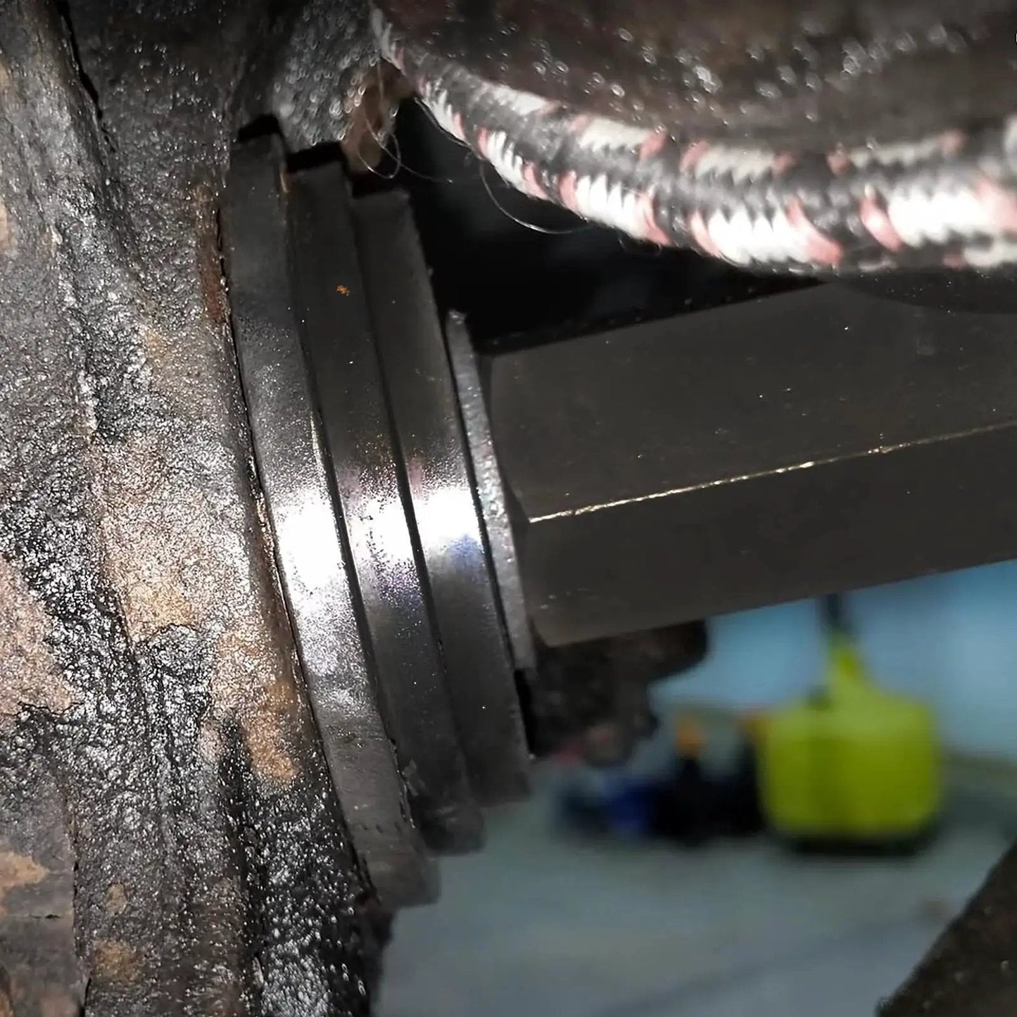 Close-up of Front Wheel Drive Bearing Press Kit 23 Piece Bearing Puller Set installed on a car's wheel hub, showing sliding screws.