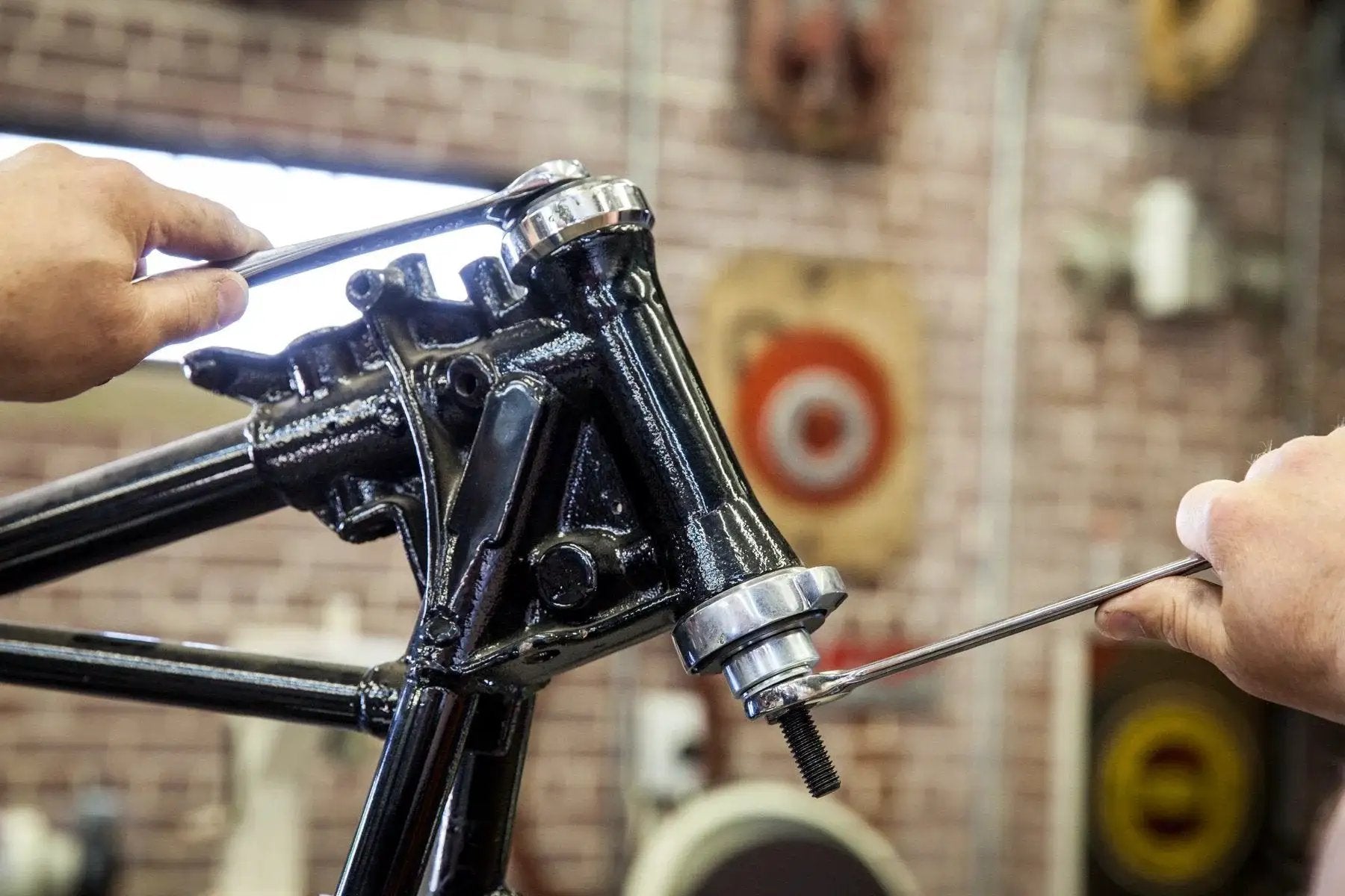 Using Steering Head Bearing Installer for Harley-Davidson motorcycles on frame in workshop, ensuring straight damage-free installation.