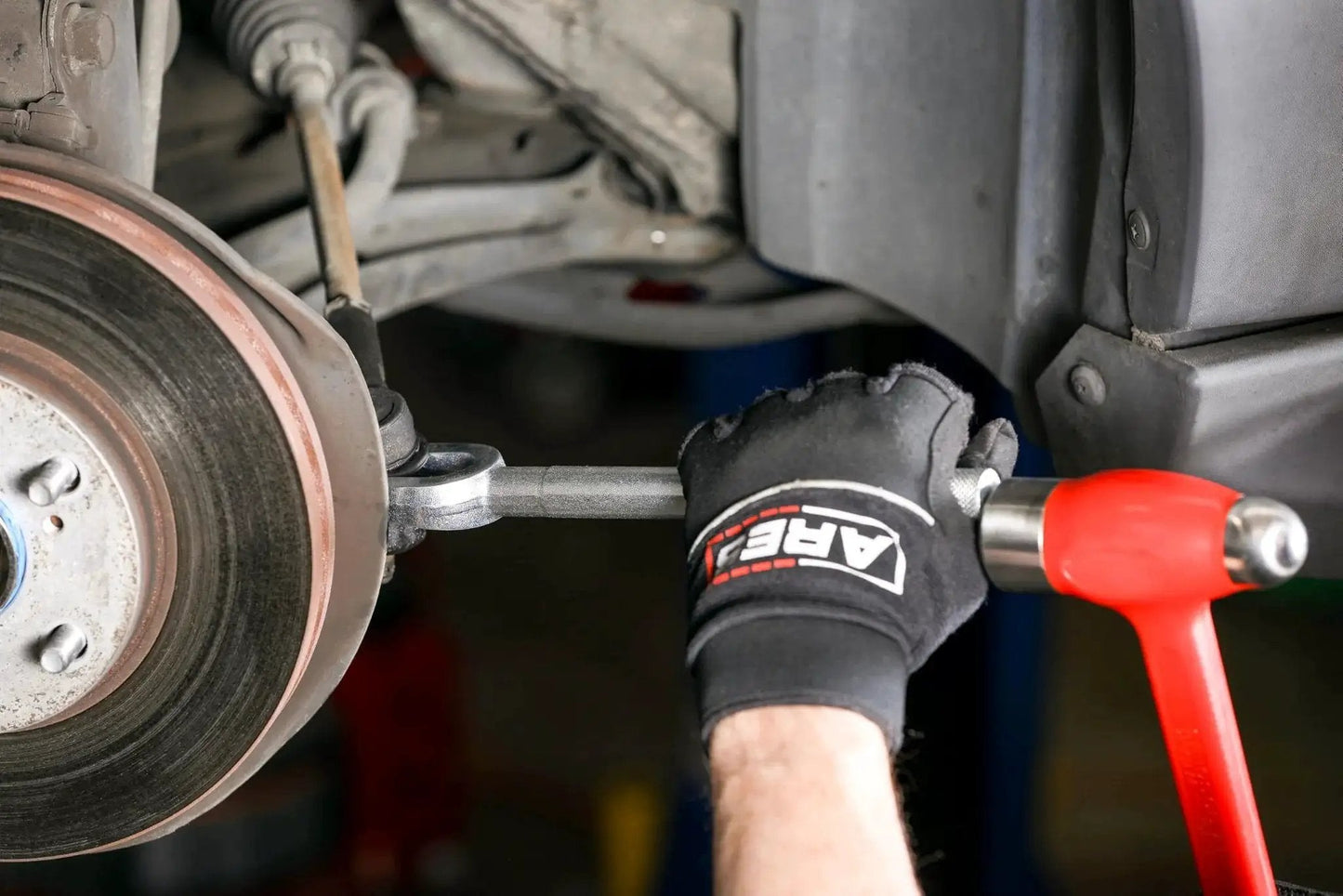 Ball Joint Separator Pickle Fork 15/16 Inch Tapered Fork with Knurled Handle being used to separate car ball joint