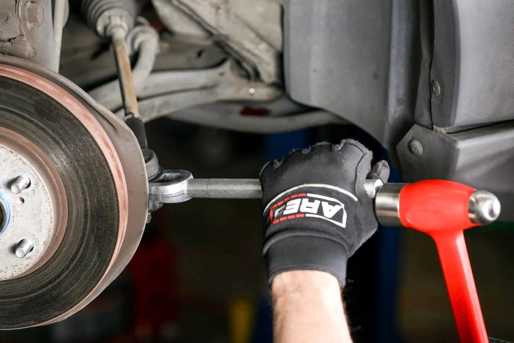 Ball Joint Separator Pickle Fork 15/16 Inch Tapered Fork with Knurled Handle being used to separate car ball joint