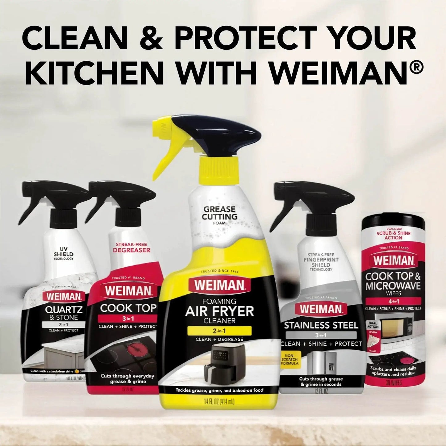 Assorted Weiman cleaning products, including Foaming Air Fryer Cleaner Kit with Non Abrasive Sponge for Ceramic Baskets, on a countertop
