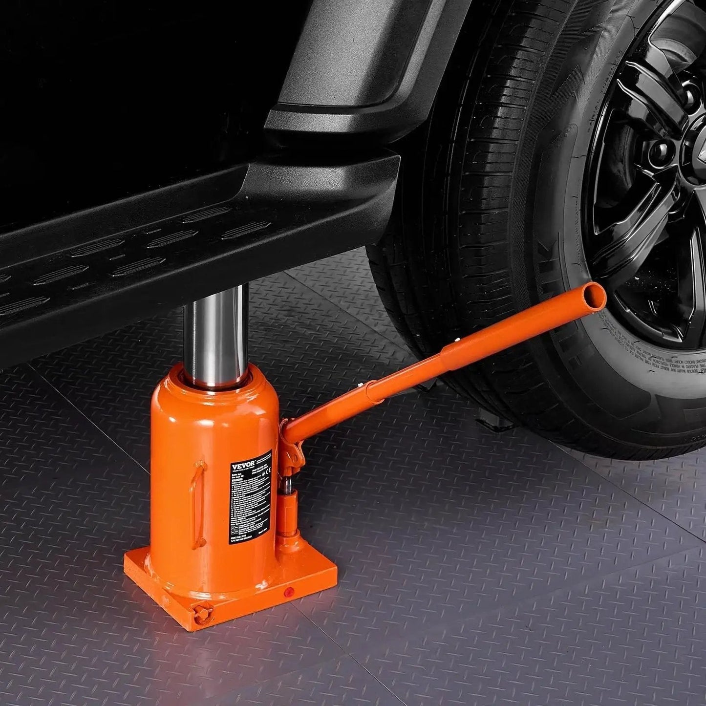 50 Ton Hydraulic Bottle Jack With 11 To 17 Inch Lift And 3 Section Handle lifting vehicle in garage setting