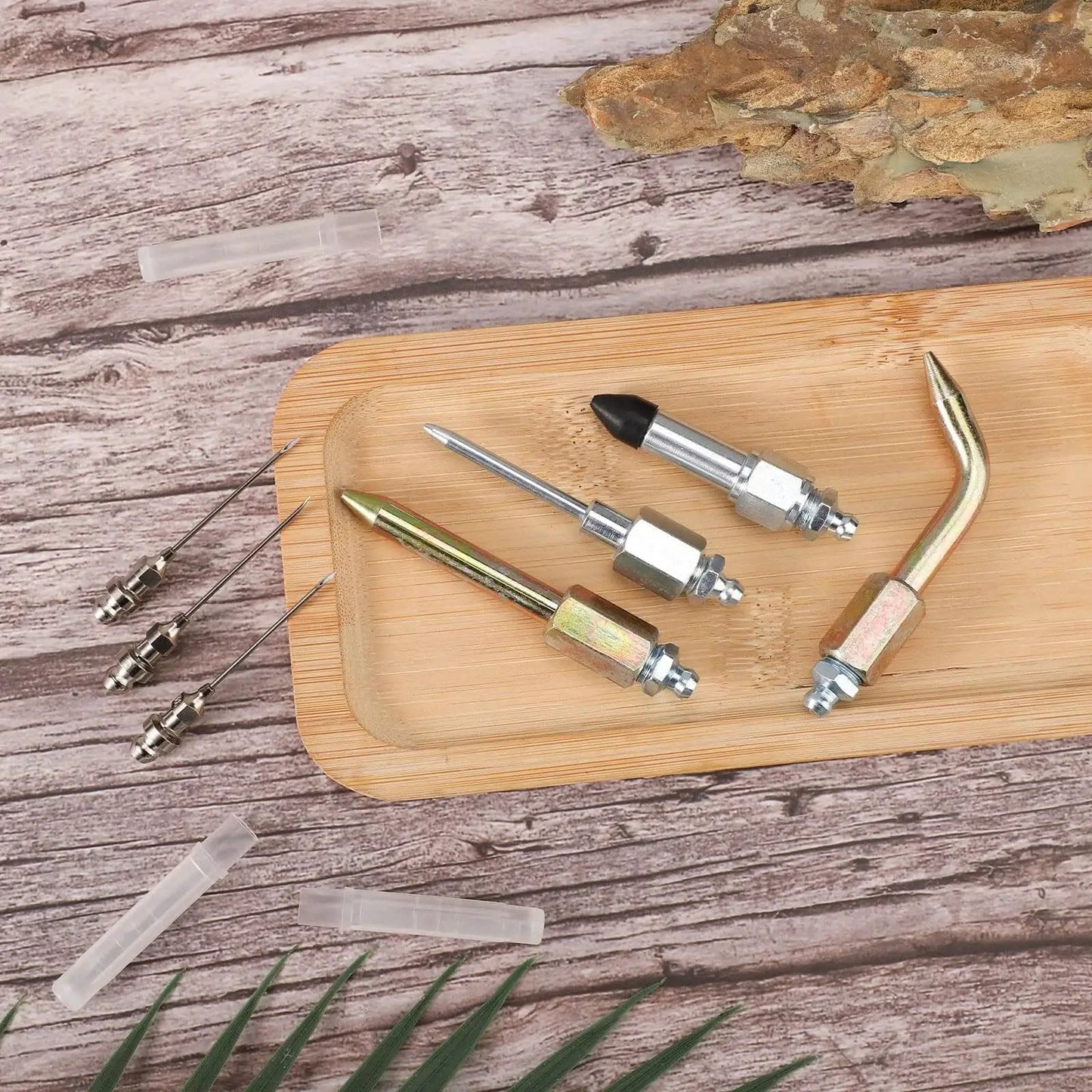 Must Have Versatile Seven Piece Grease Gun Accessory Kit With Three Nozzles One Needle Dispenser One Rubber Joint Tip One Straight Nozzle And One Bent Nozzle For Small And Confined Spaces Lyreh on wooden tray