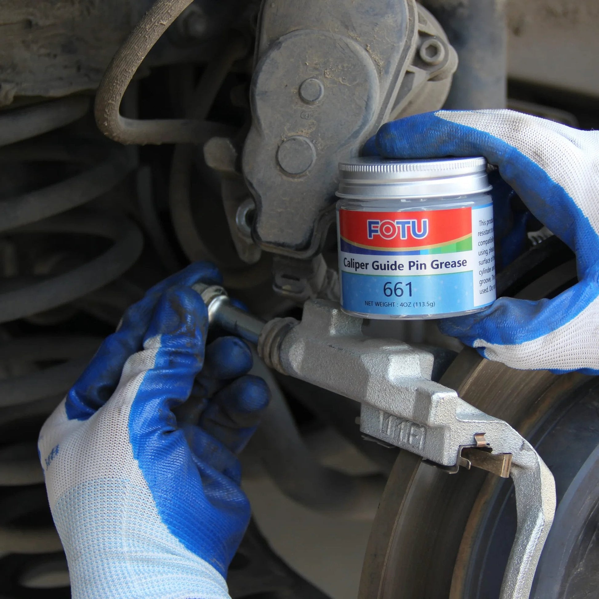 Mechanic applying FOTU 661 High Temperature Resistant Brake Caliper Guide Pin Lubricant for smooth braking
