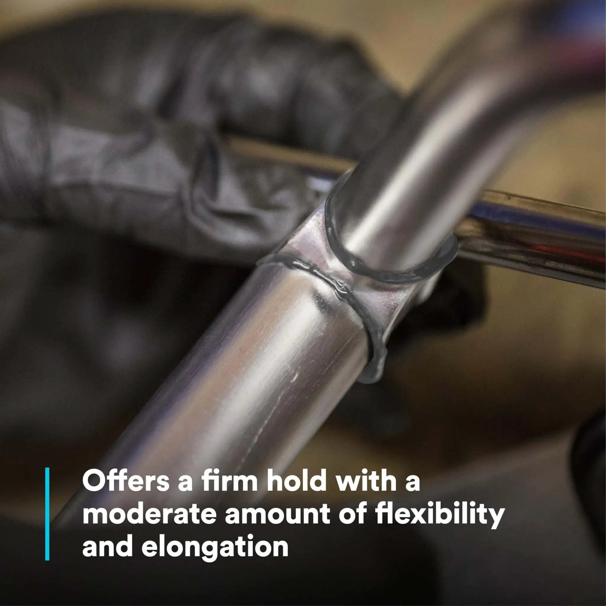 Close-up of DP190 Gray Epoxy Adhesive Duo-Pak 48.5 mL bonding metal pipes showcasing high shear and peel strength for construction.