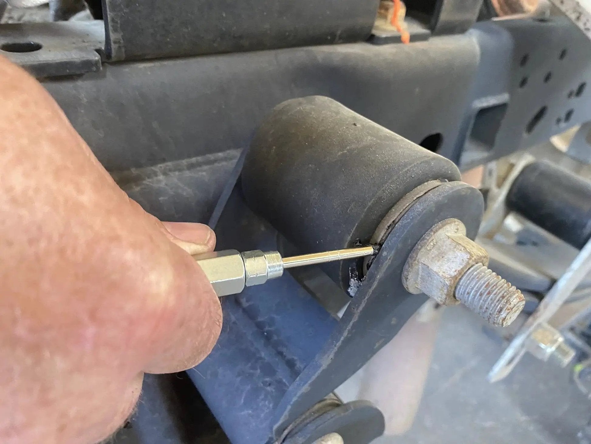 Needle Nozzle Accessory For Handheld Grease Guns With Hardened Steel Tip 1/8 Inch Female NPT, 2.76 Inch Length in use on machinery