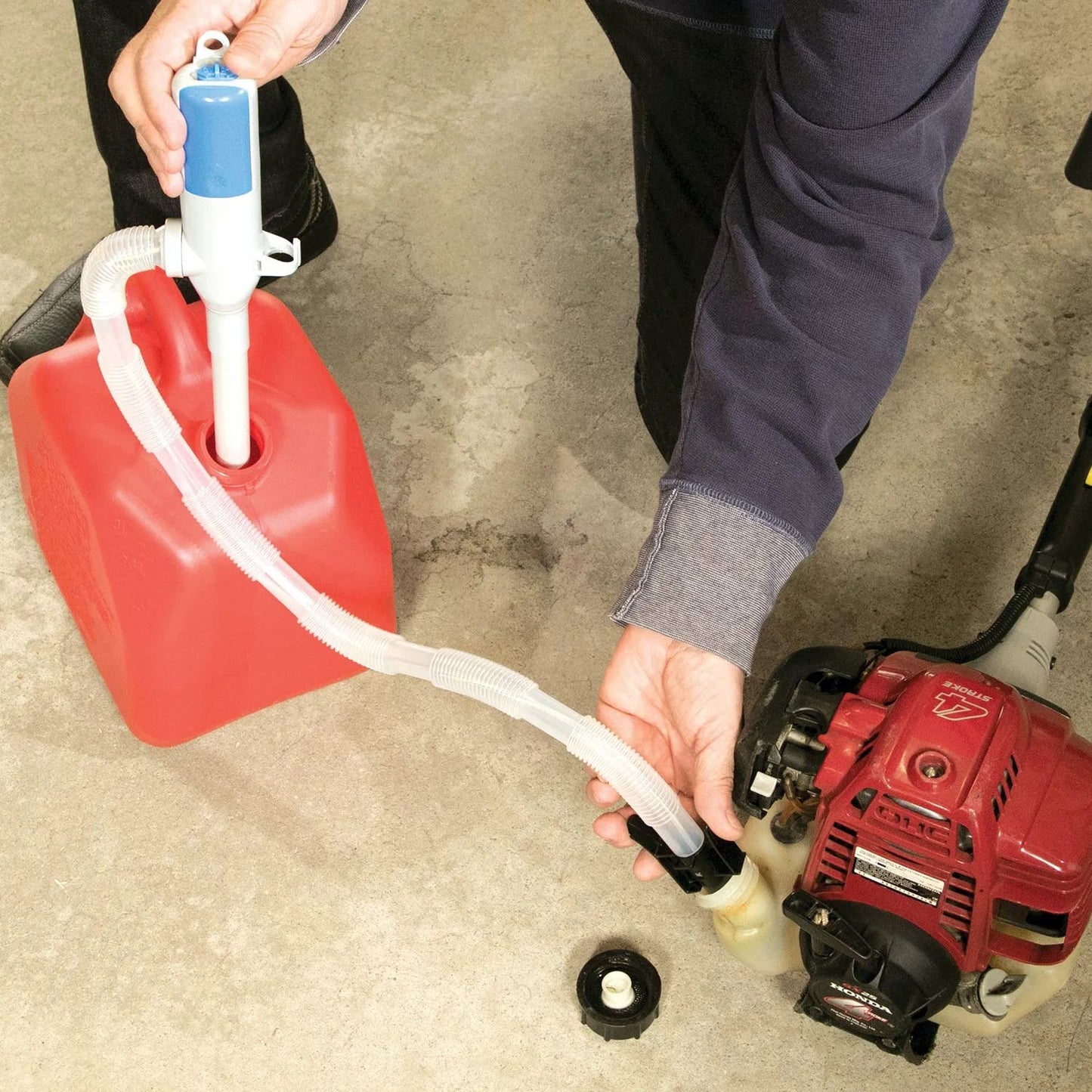 Turbo Pump Automatic Liquid Transfer Pump Cordless With Three Foot Hose Auto Stop Sensor in use with a red fuel container