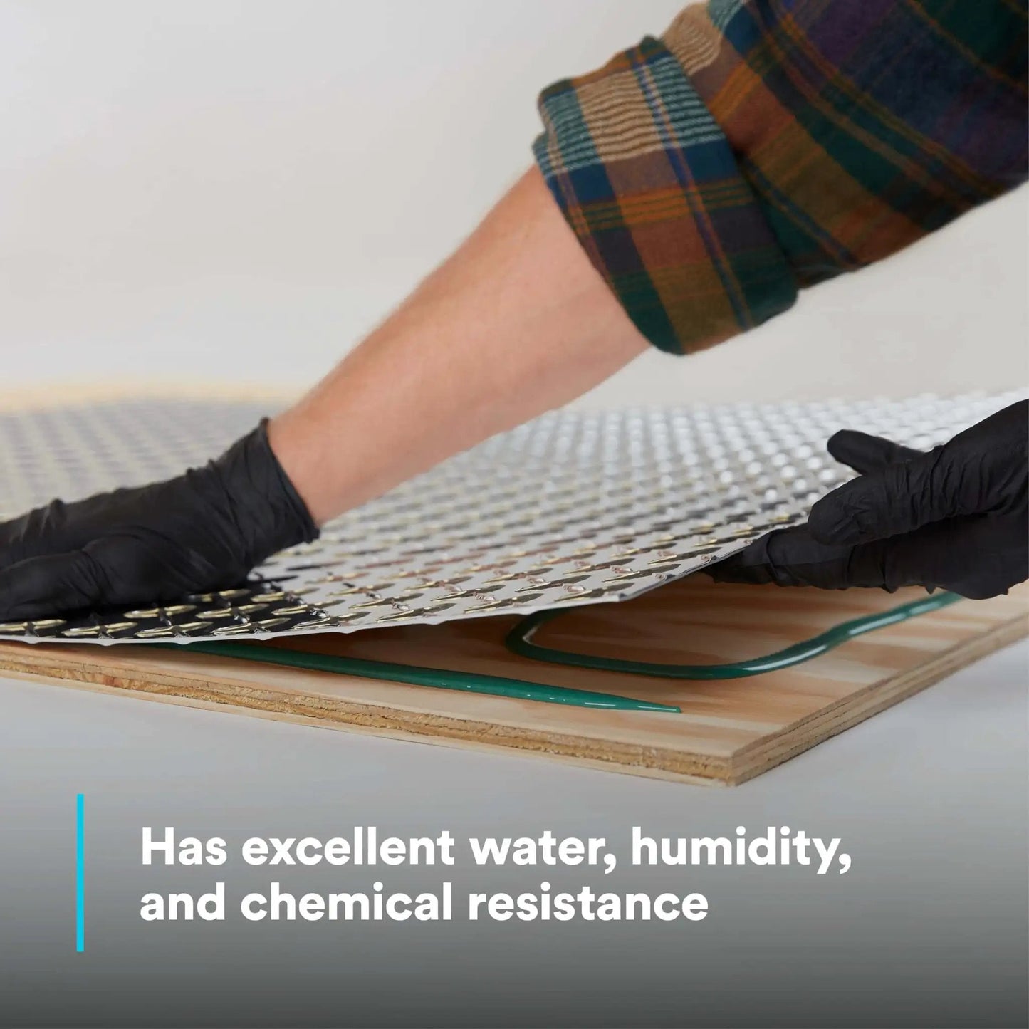 Applying composite urethane adhesive DP6310NS, green two-part non-sag paste for multi-material assemblies, on wooden board.