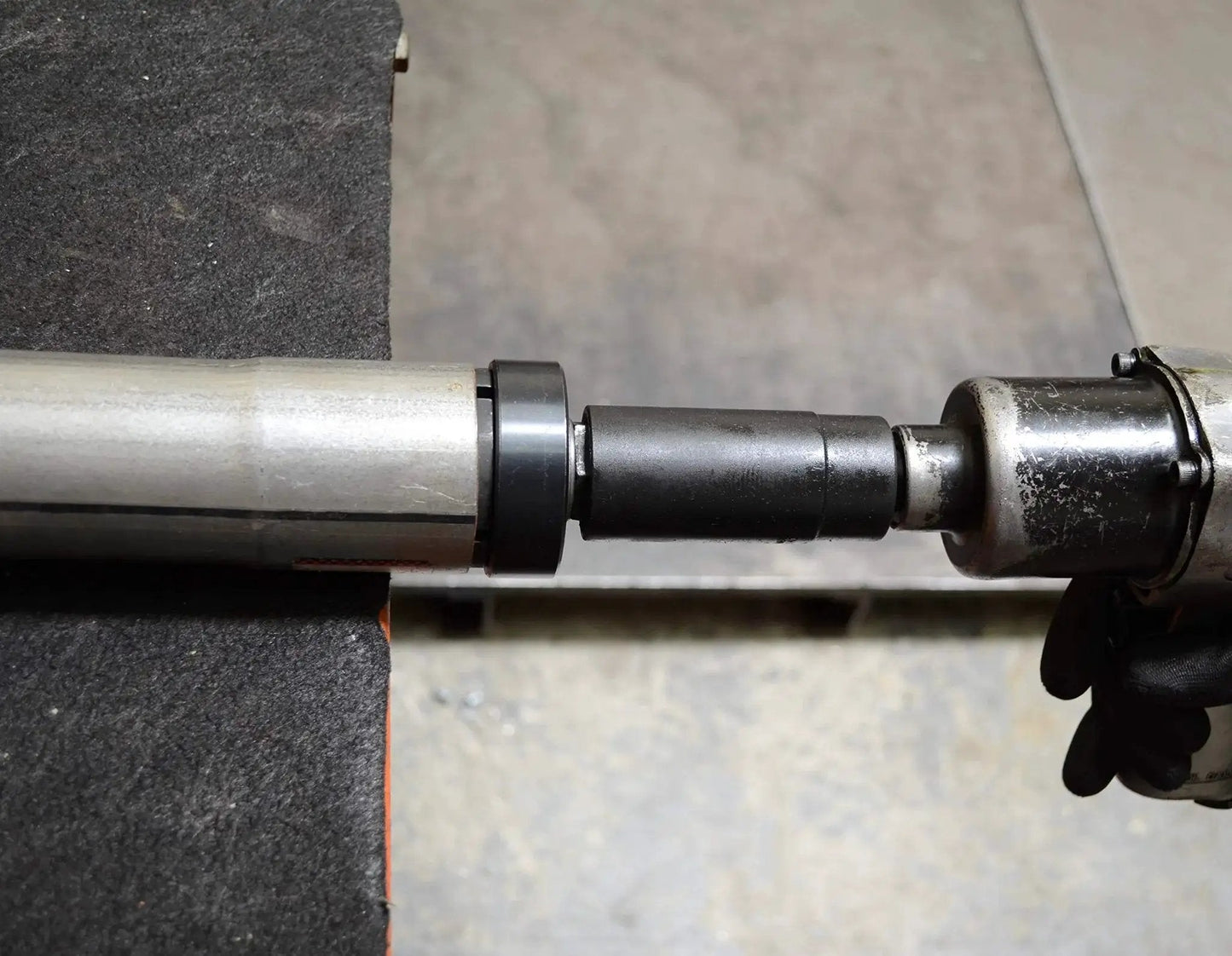 Exhaust Pipe Stretcher Kit Heavy Duty Expander For Small To Large Exhaust Piping in use, showing steel expander tool on pipe.