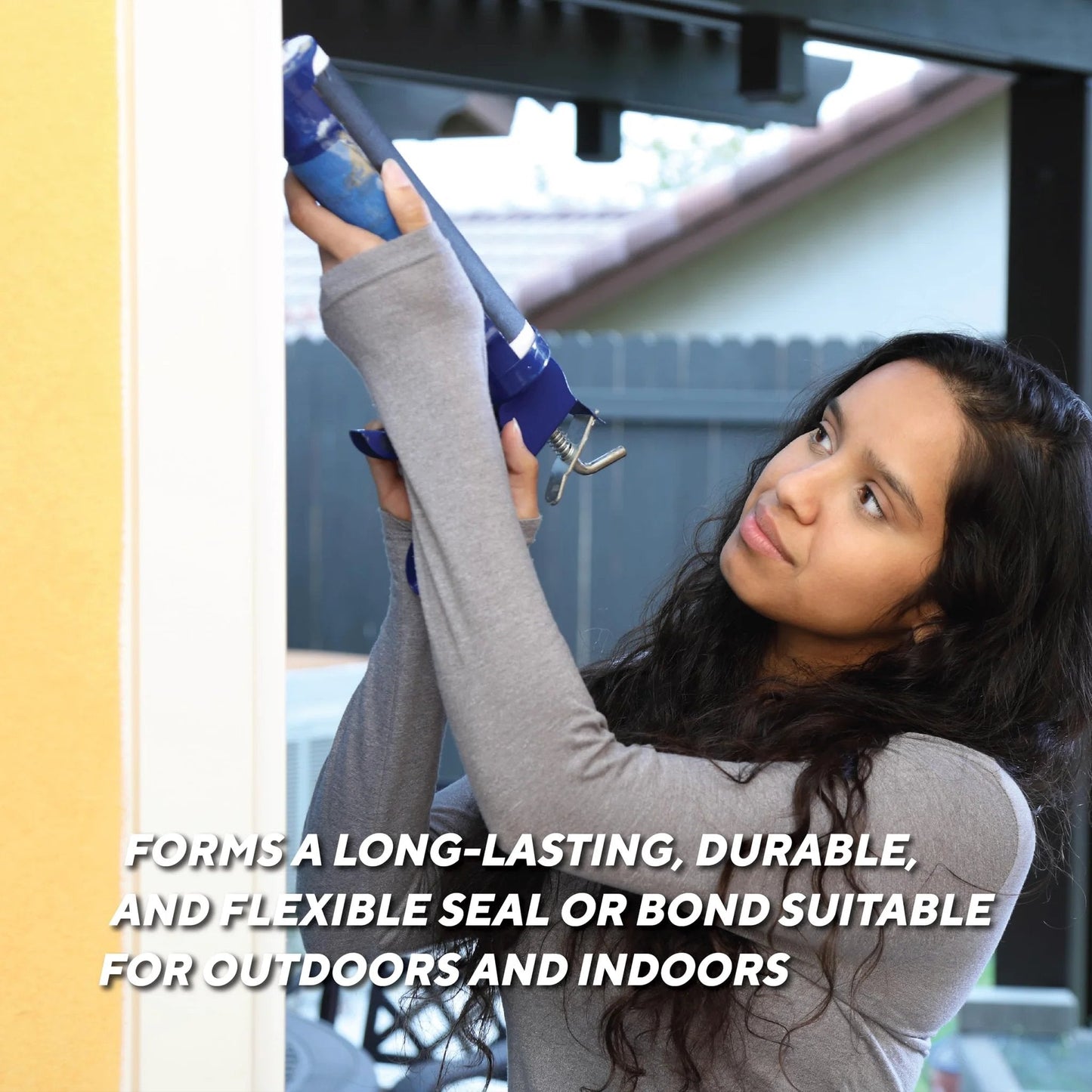 Person applying high temp silicone sealant for extreme heat 500 degree RTV black gasket maker on a door frame outdoors.