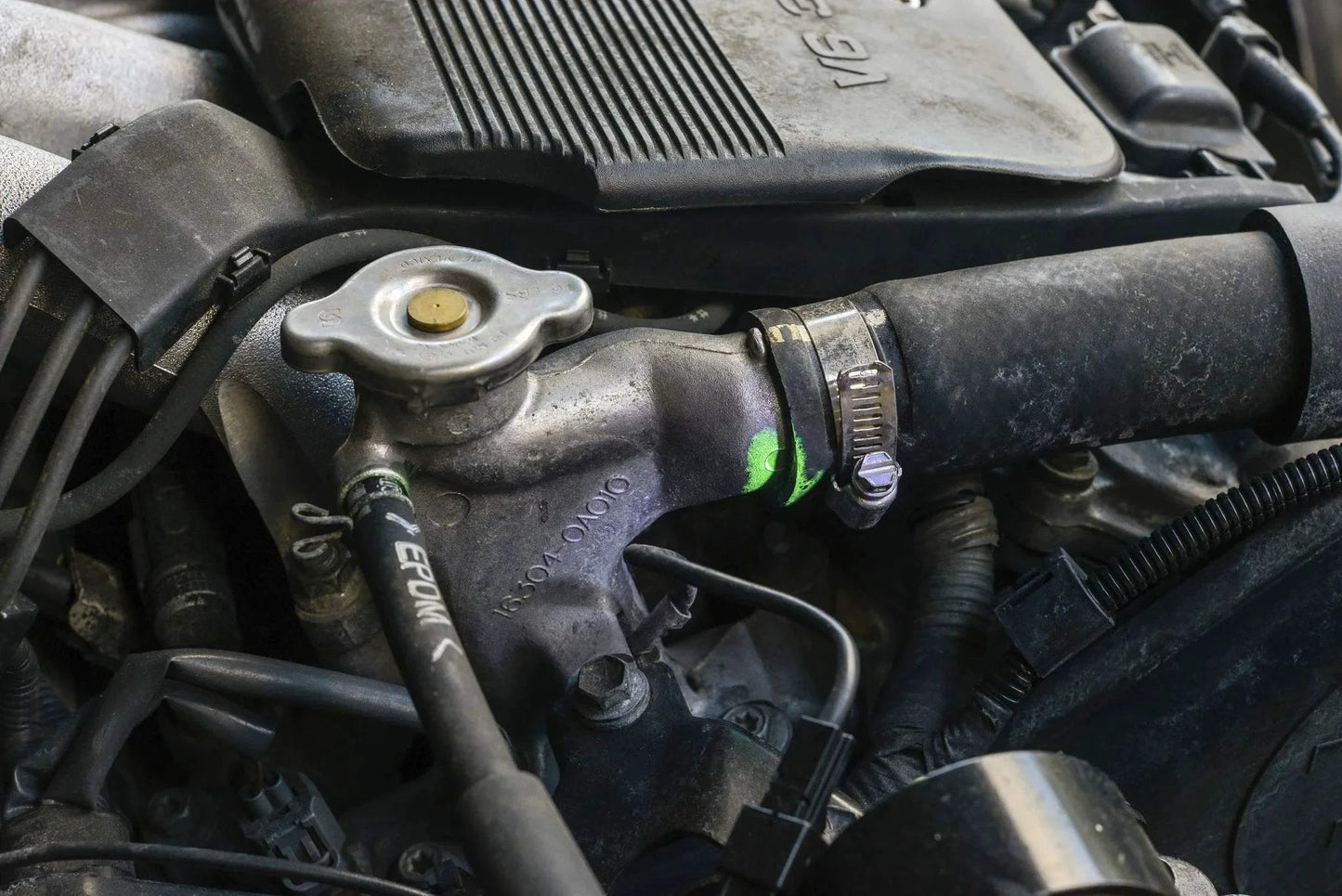 Ultraviolet Fluorescent Automotive Leak Detection Dye For Coolant Systems That Spots Leaks In Radiators Hoses Heater Cores Water Pumps And Fittings 1oz Bottle Made In USA From TRACER LEAKFINDER LF3001CS highlighting engine radiator leak