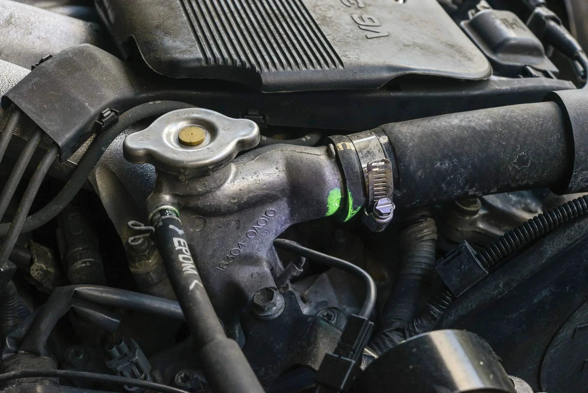Ultraviolet Fluorescent Automotive Leak Detection Dye For Coolant Systems That Spots Leaks In Radiators Hoses Heater Cores Water Pumps And Fittings 1oz Bottle Made In USA From TRACER LEAKFINDER LF3001CS highlighting engine radiator leak
