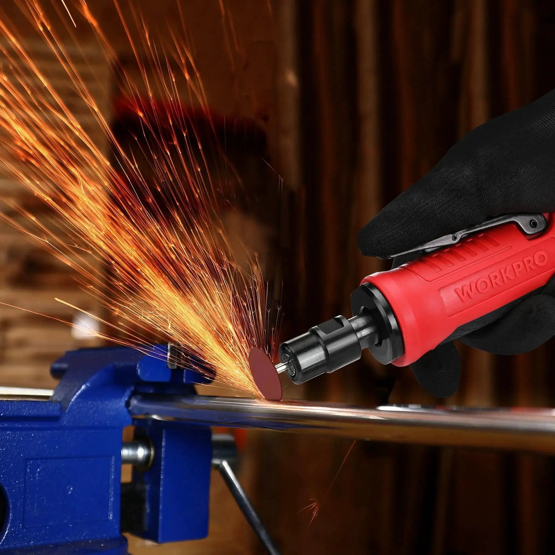 Powerful One Quarter Inch Pneumatic Straight Die Grinder With 25,000 RPM used for metal grinding, sparks visible, red casing.