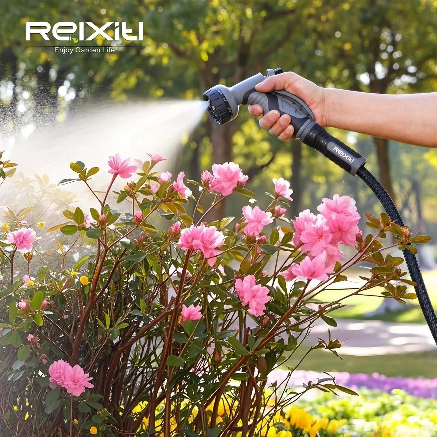 Ultra Lightweight Non Expanding Garden Hose With 10 Function Sprayer watering pink flowers in garden