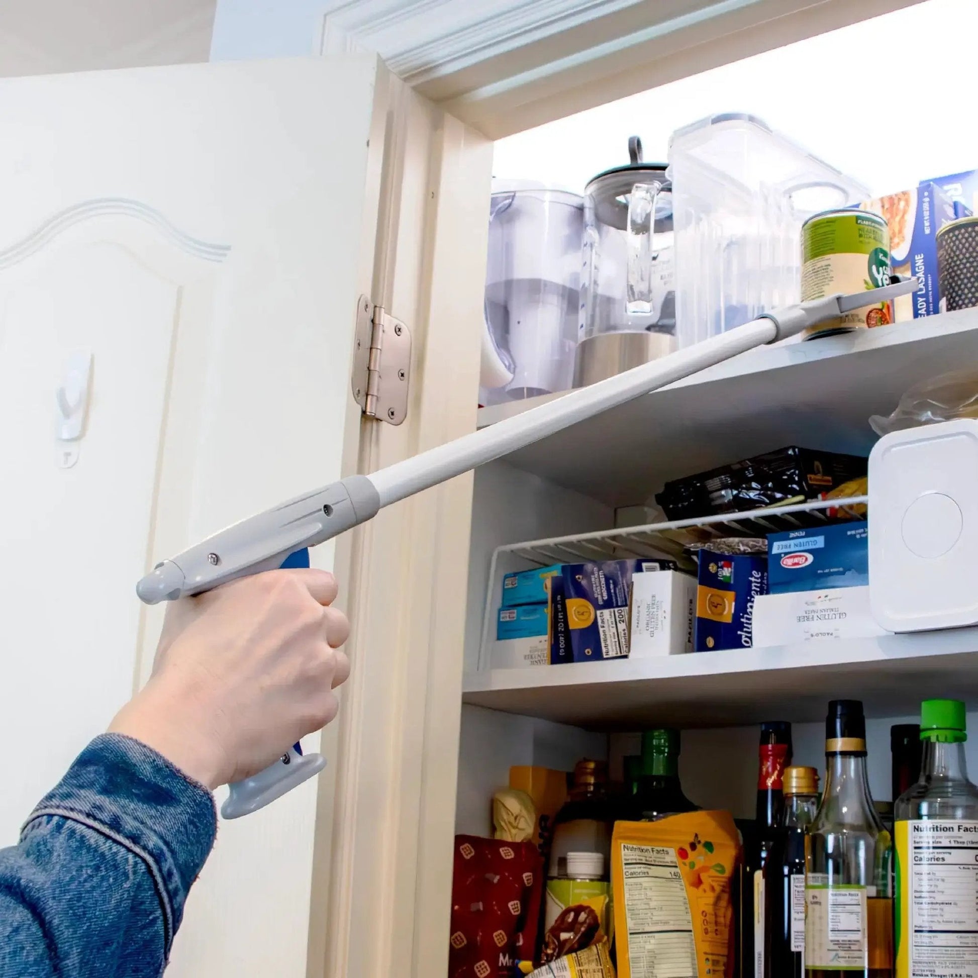 Person using 32 Inch Grabber Plus Reacher Tool With Built In Magnet For Trash Pickup And Yard Cleanup Ergonomic Trigger Grip Claw in kitchen