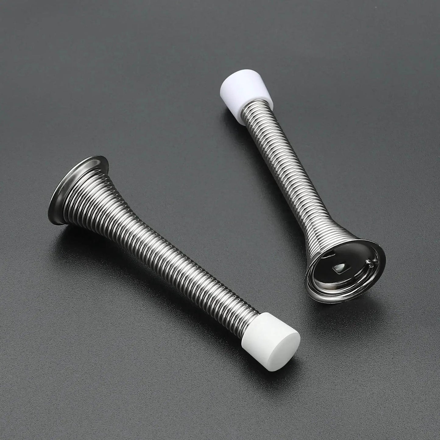 Spring Door Stops With Rubber Bumpers Satin Nickel 12 Pack For Bottom Of Door, showing two stops with rubber tips on black surface.